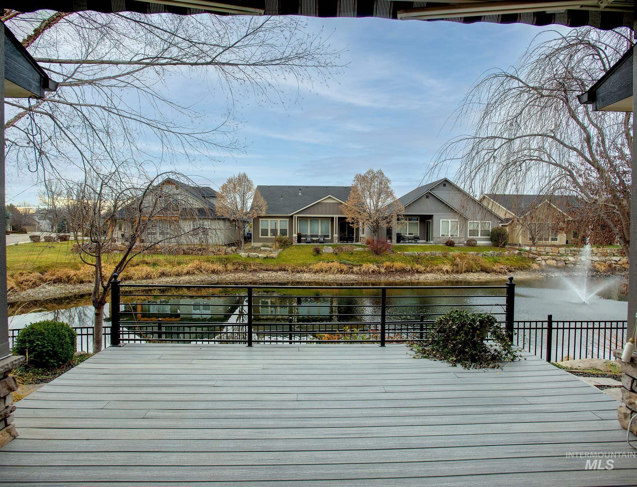 Wooden deck with a water view and a residential view