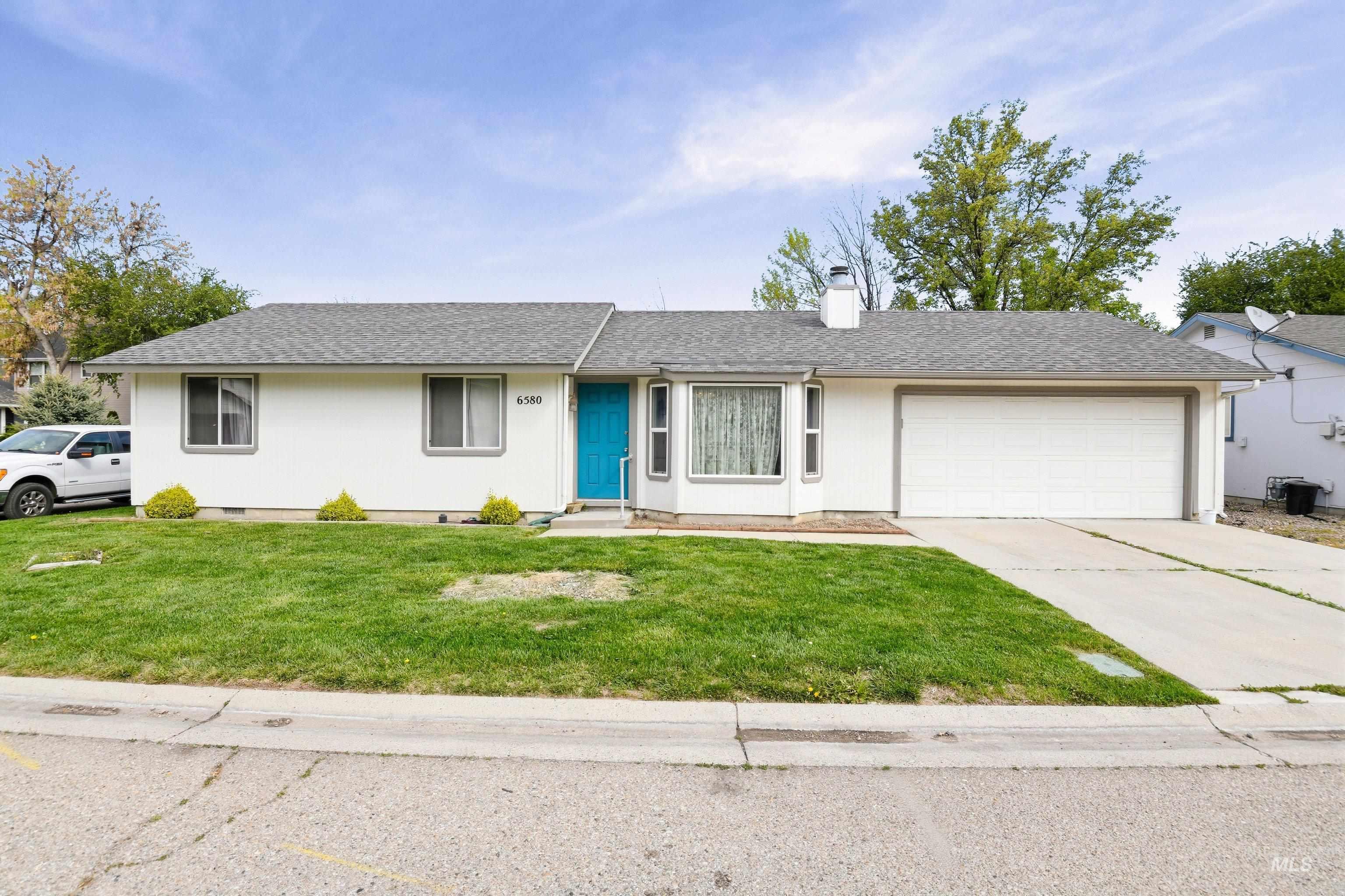 Single story home featuring roof with shingles, a chimney, a front lawn, a garage, and concrete driveway