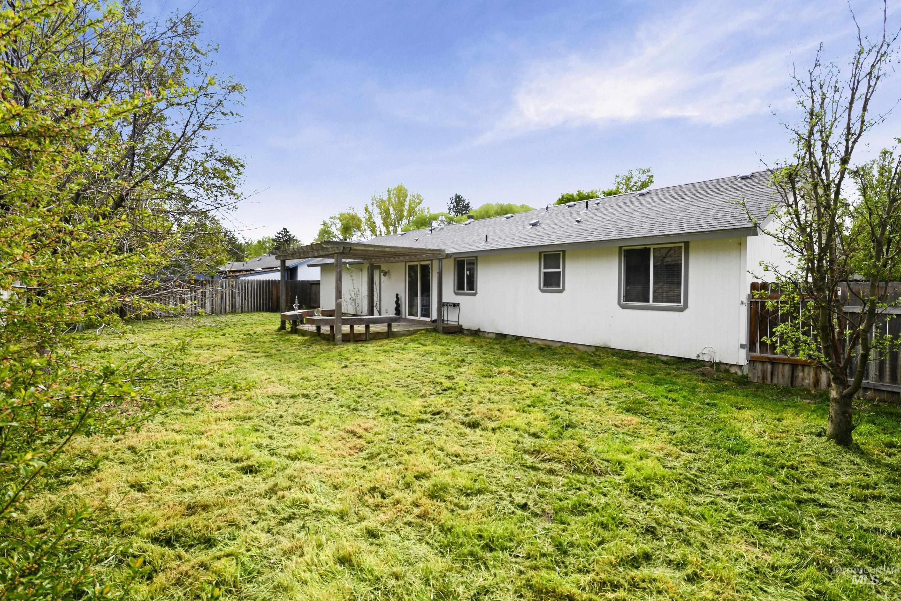 Rear view of property featuring a patio area and a fenced backyard