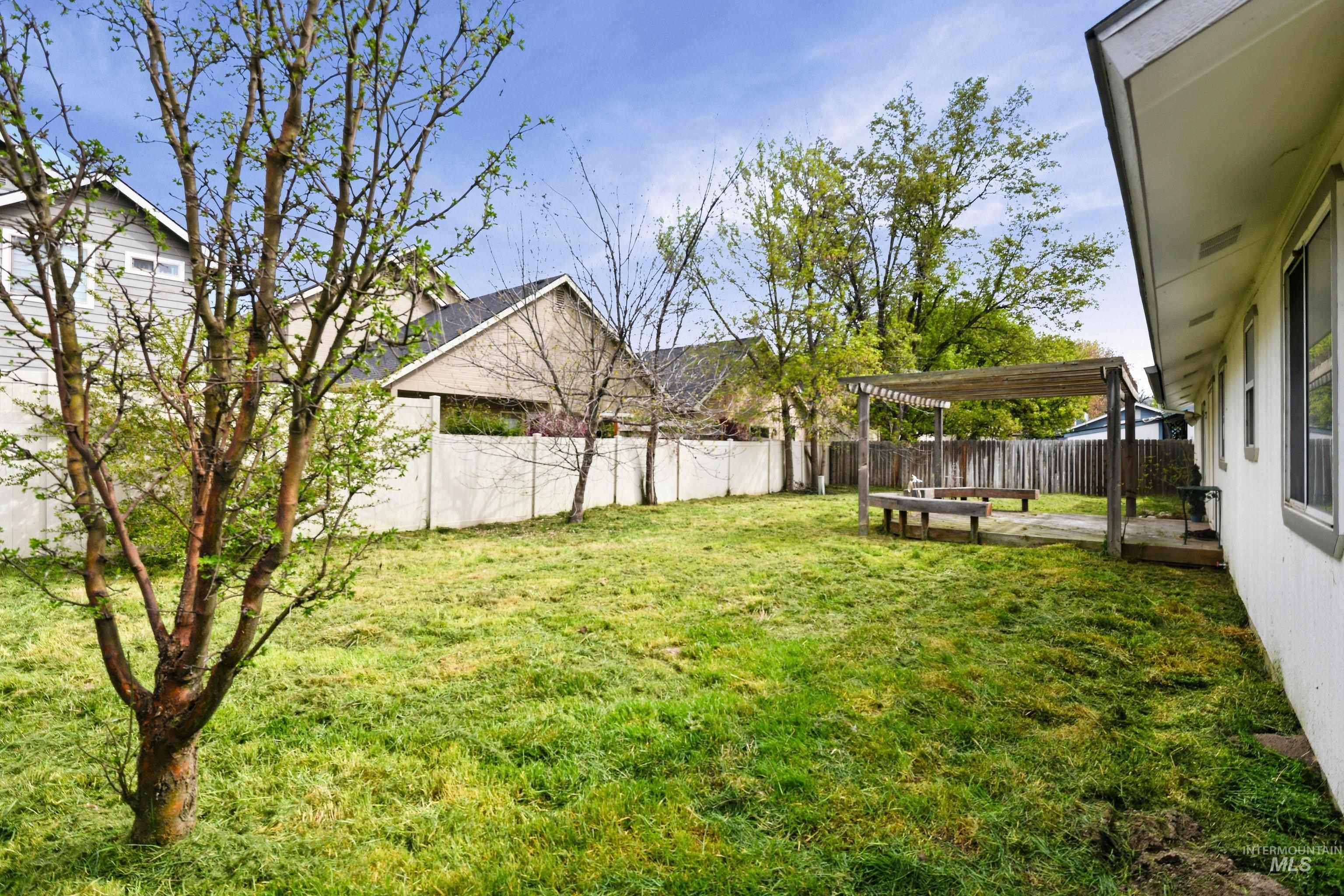Fenced backyard with a pergola