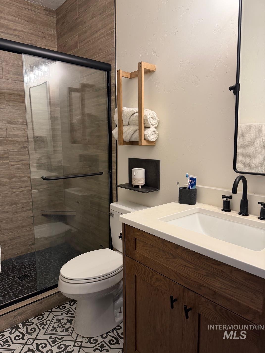 Bathroom featuring vanity and a stall shower