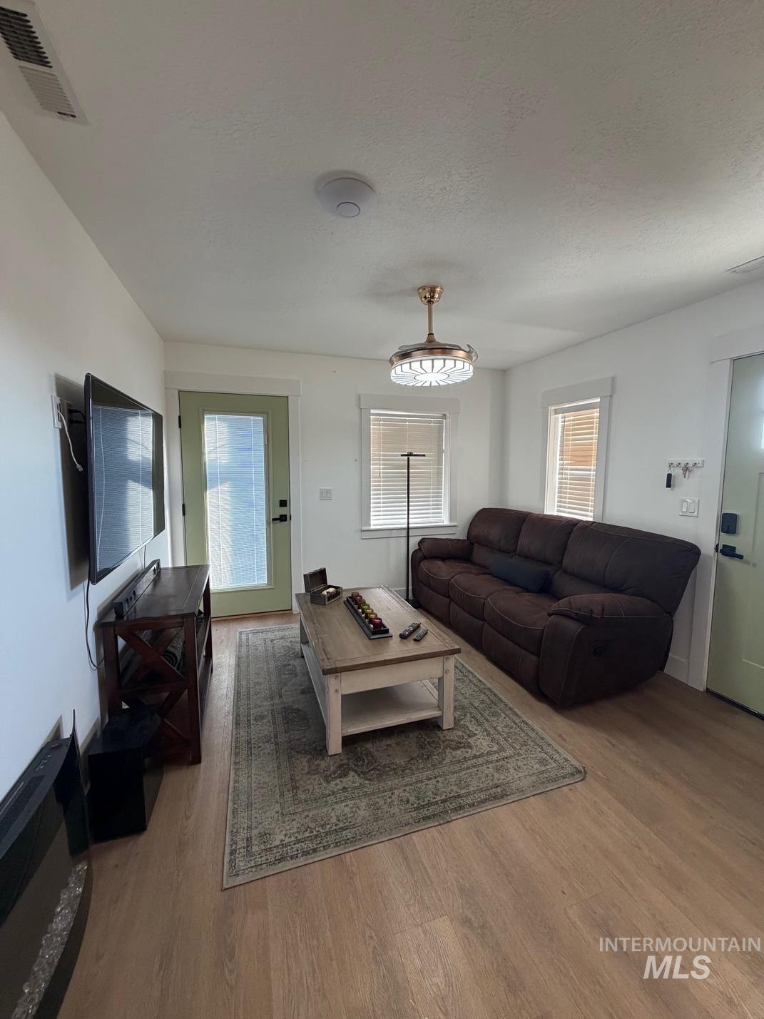 Living room featuring wood finished floors and plenty of natural light