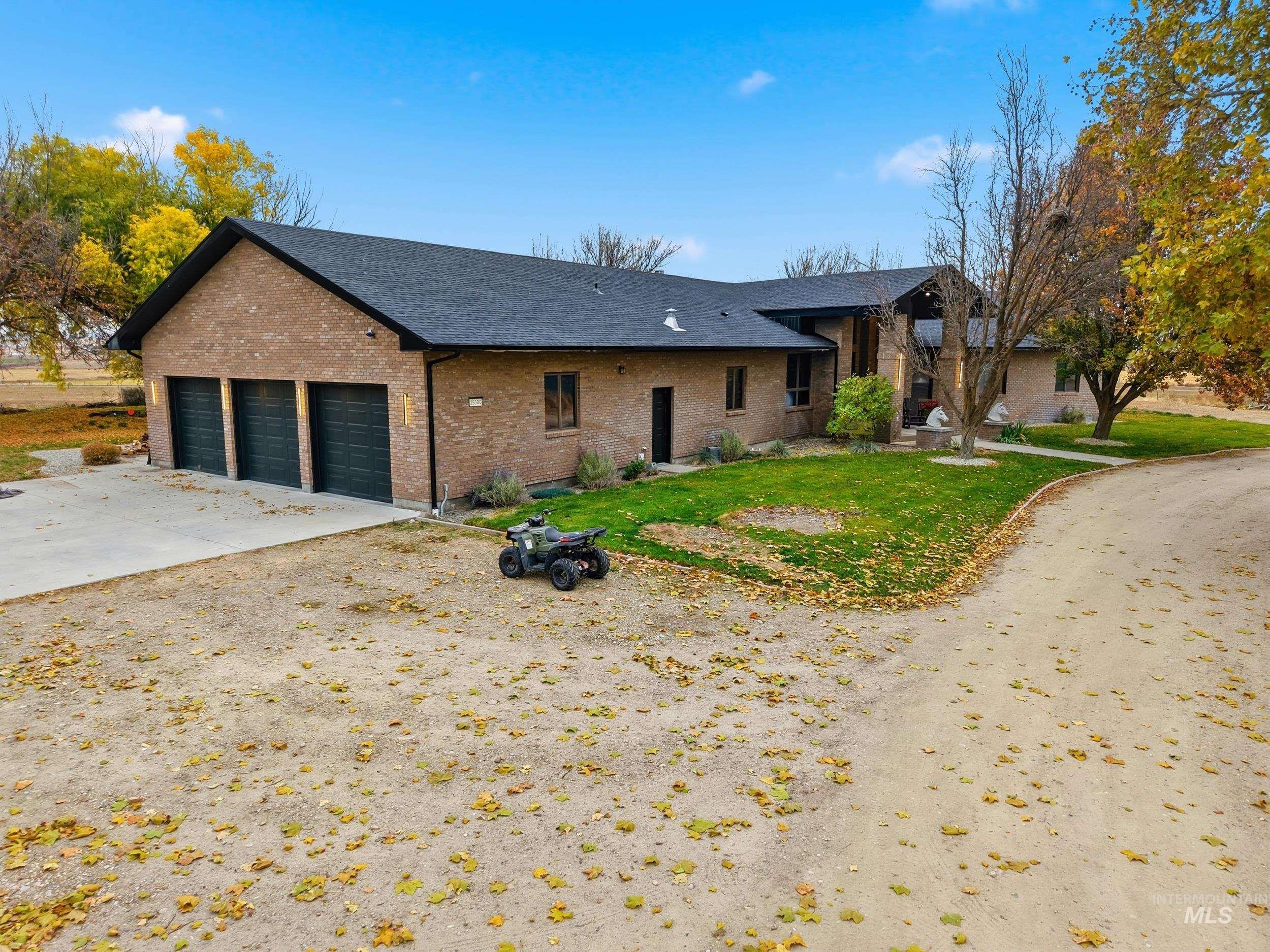 Single story home with brick siding, a shingled roof, a front yard, and concrete driveway