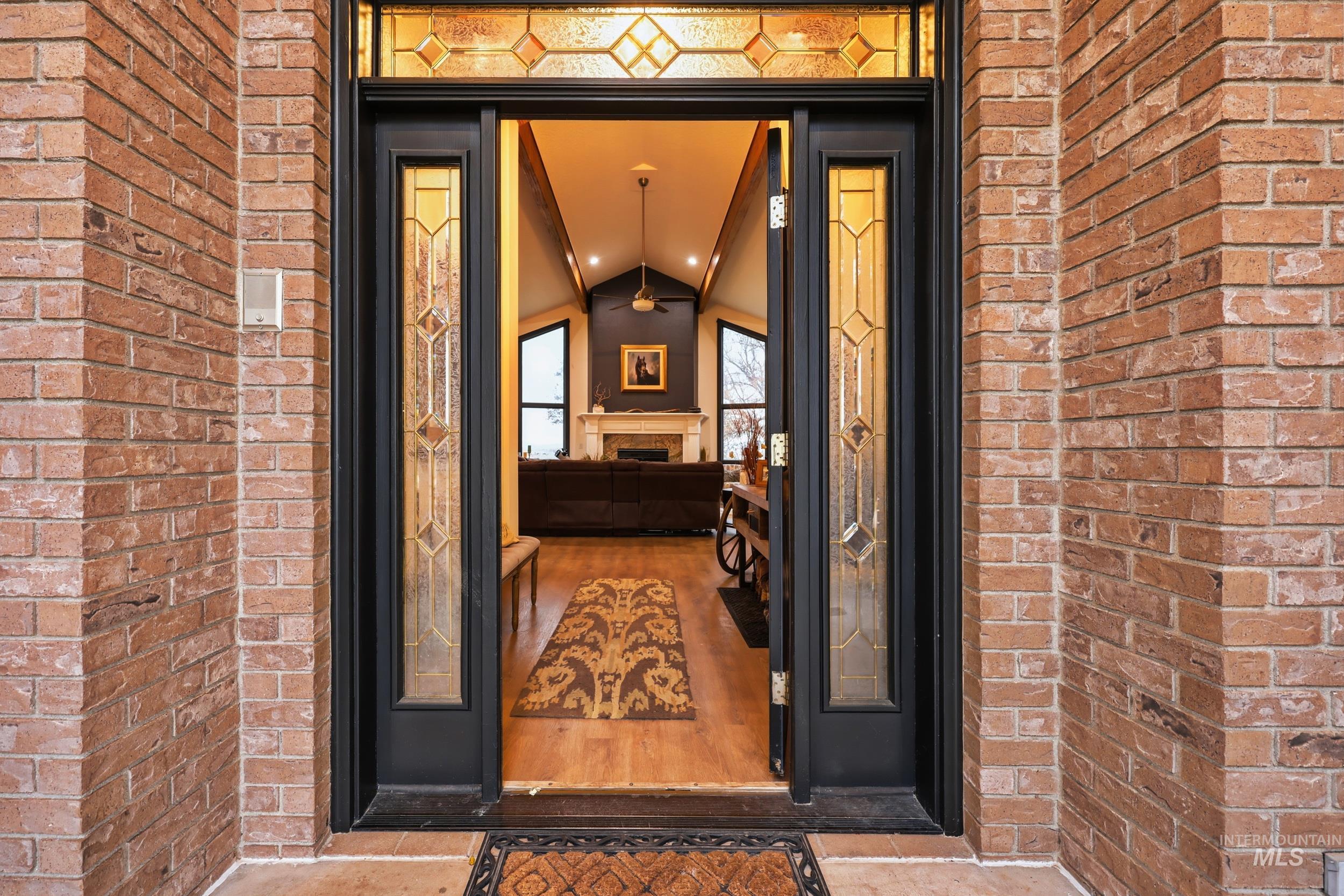 Doorway to property with brick siding