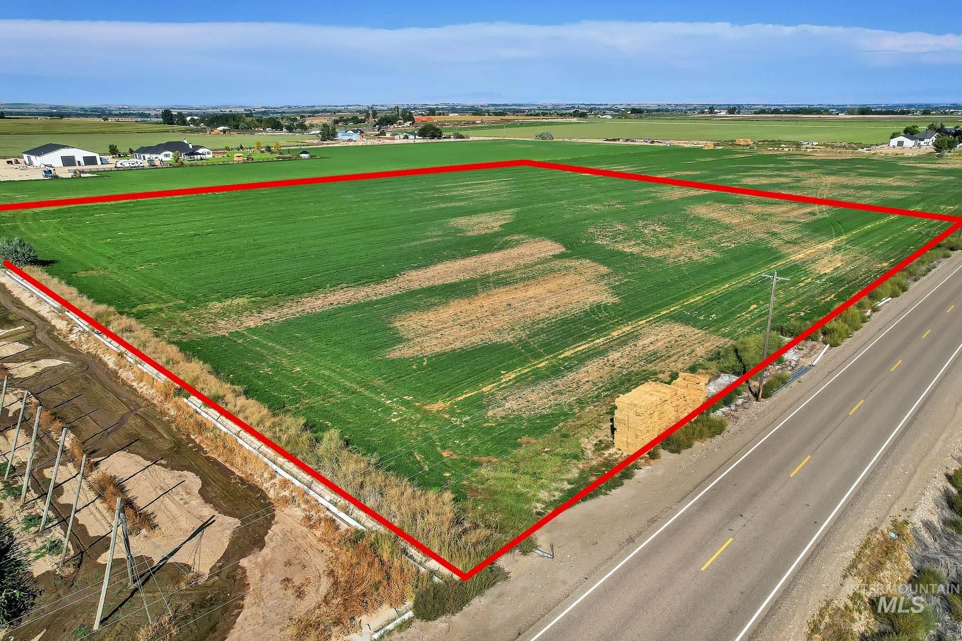 Aerial view of sparsely populated area with property parcel outlined and farmland