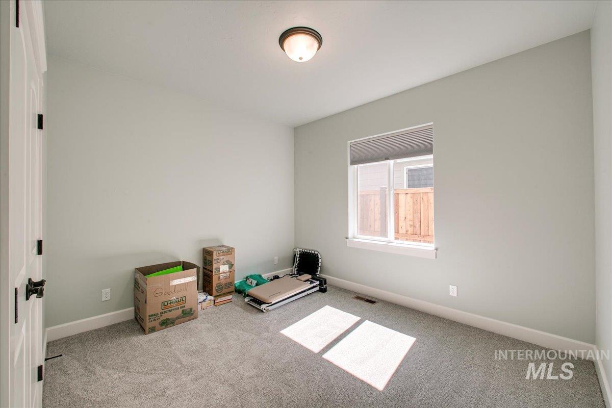Unfurnished room featuring baseboards and carpet
