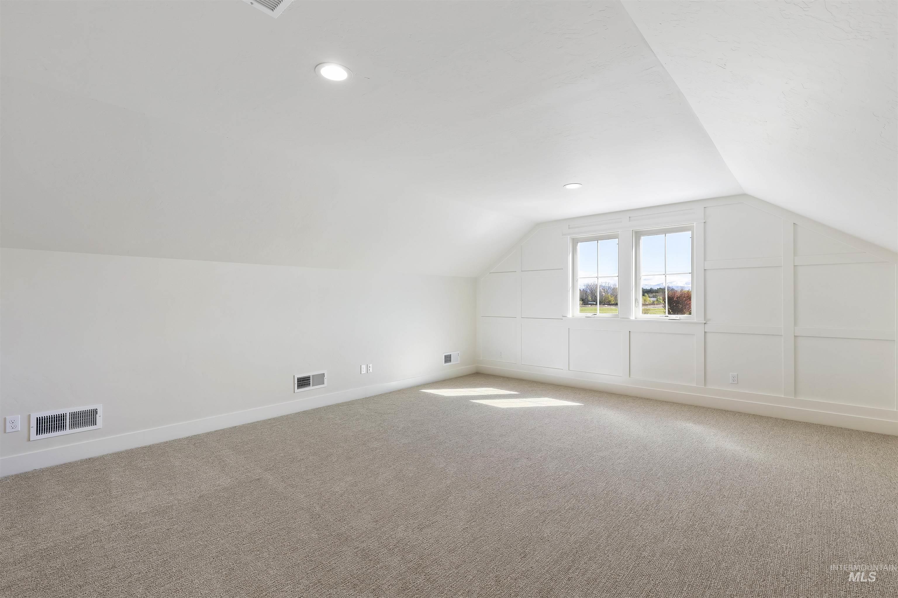 Bonus room with carpet and recessed lighting