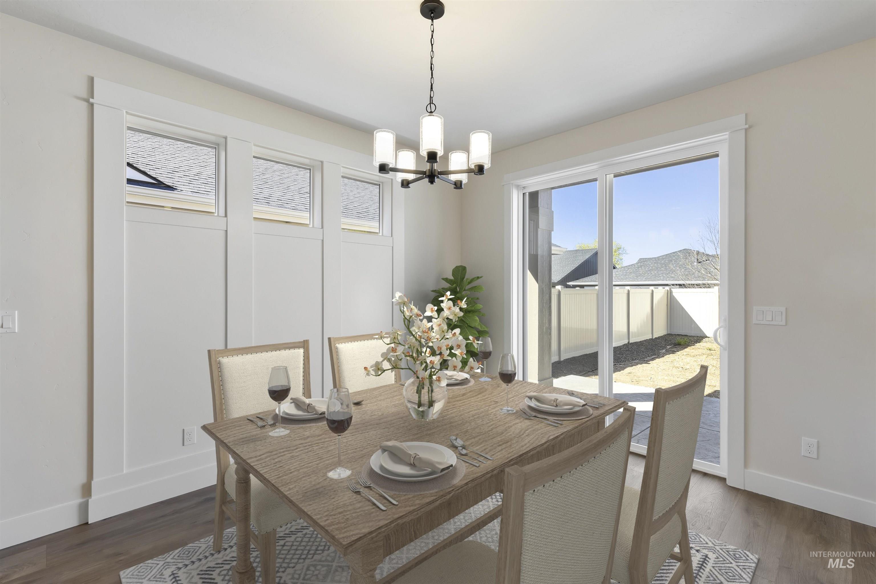 Dining room featuring dark wood-type flooring and a chandelier