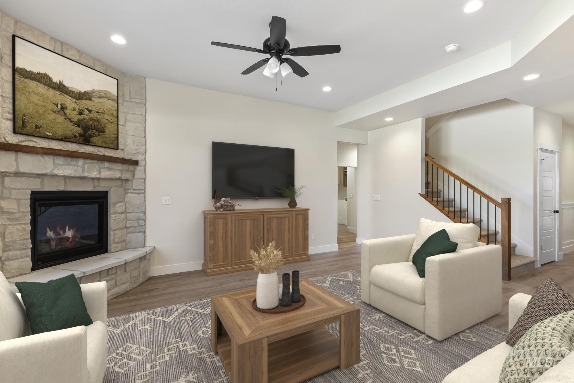 Living room with a ceiling fan, wood finished floors, a fireplace, and recessed lighting
