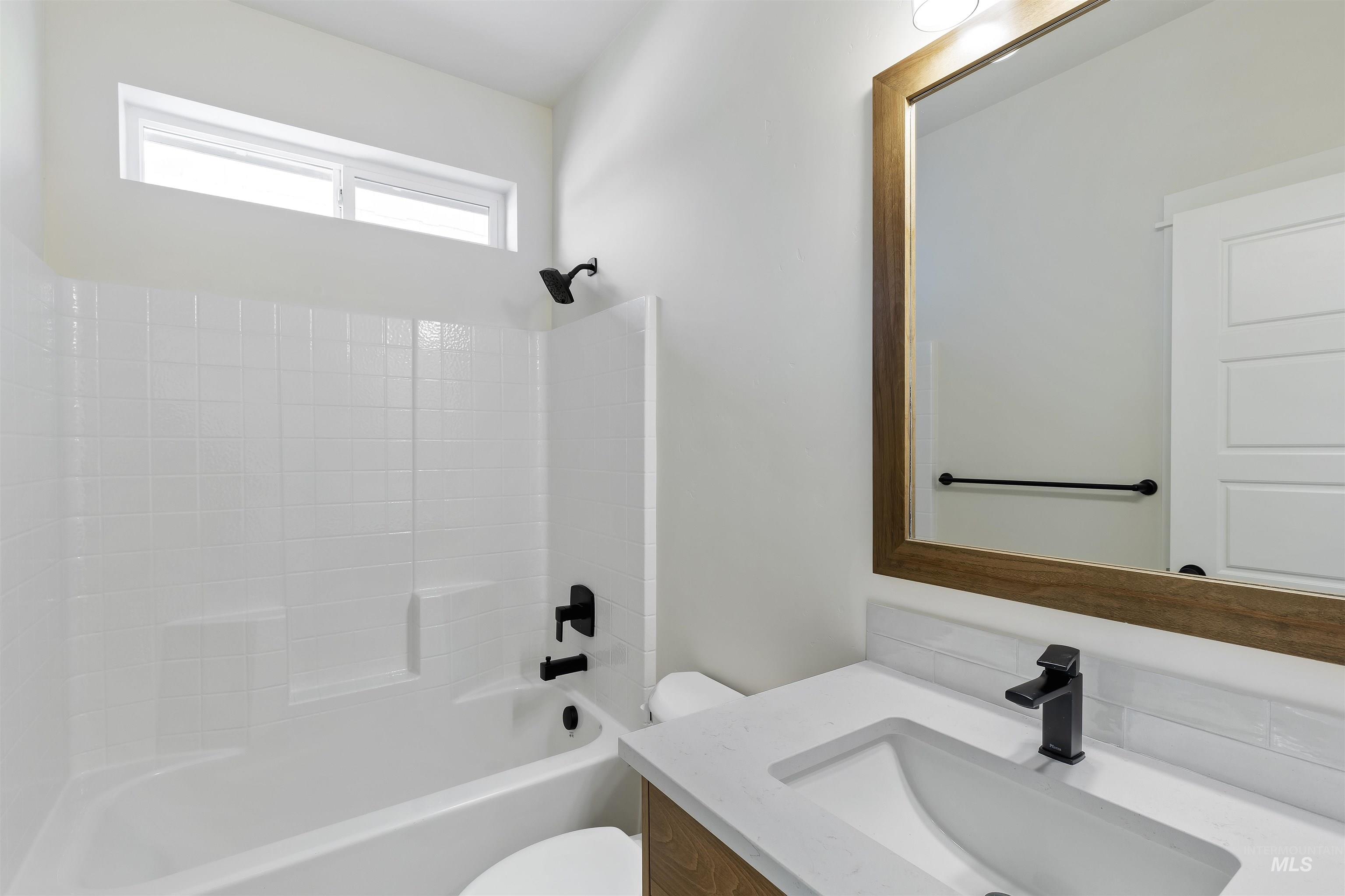 Full bath featuring  shower combination and vanity