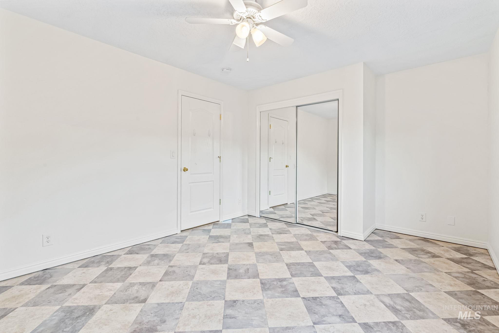 Unfurnished bedroom featuring ceiling fan and a closet