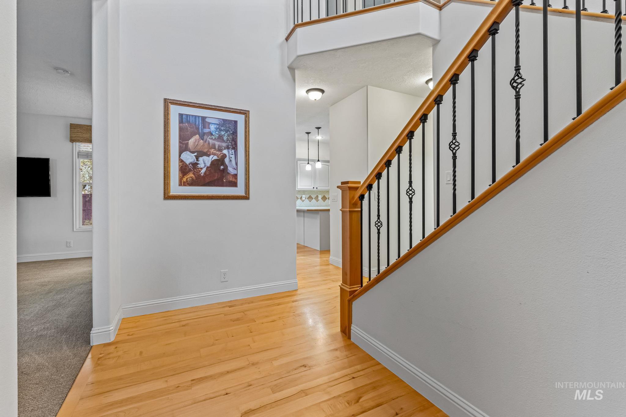 Foyer entrance with wood finished floors and stairs