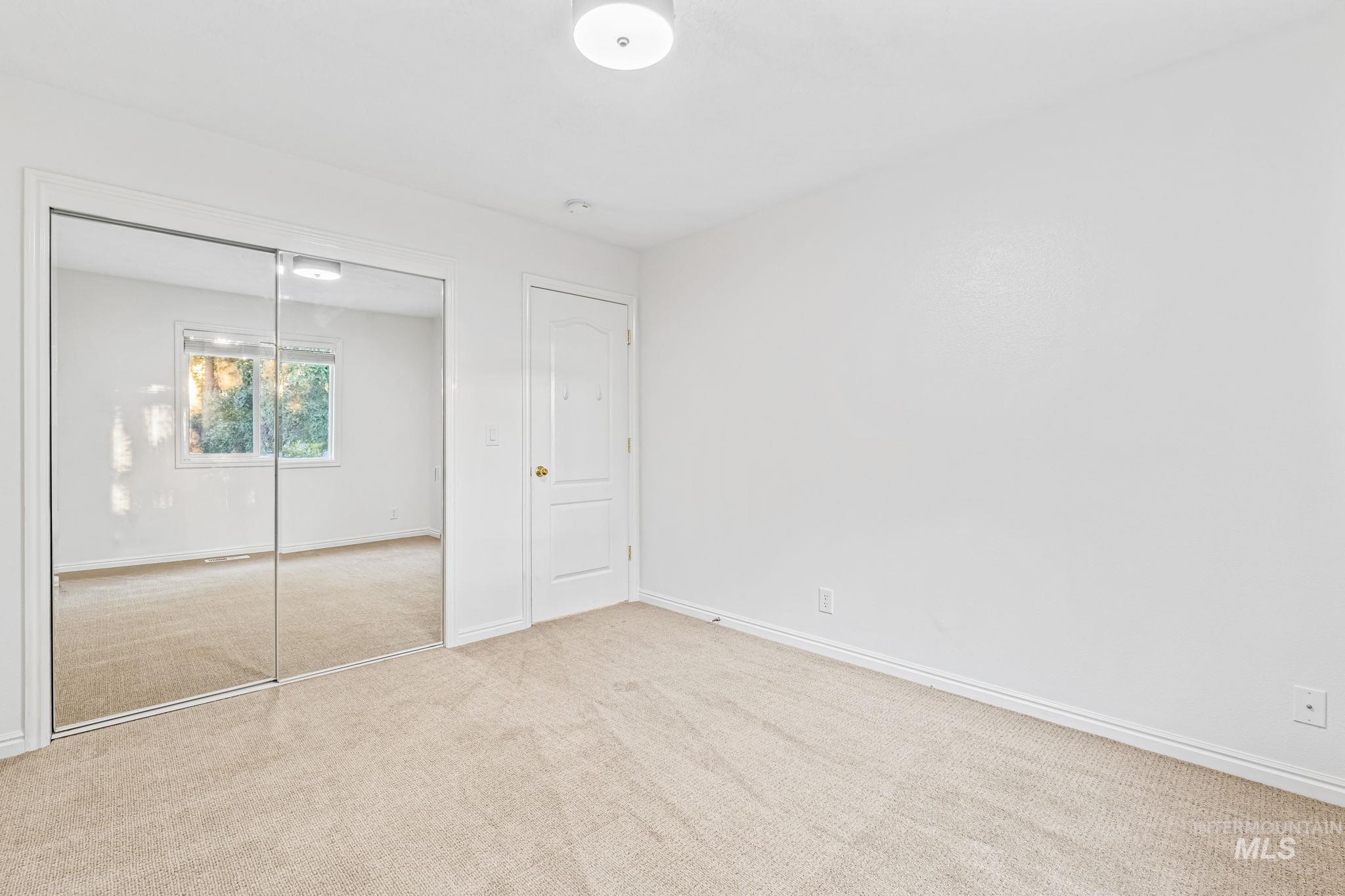 Unfurnished bedroom with carpet and a closet