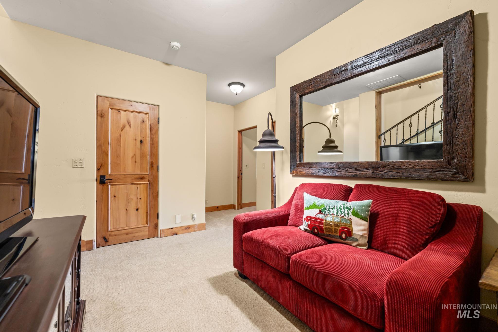 Living area with light carpet and baseboards