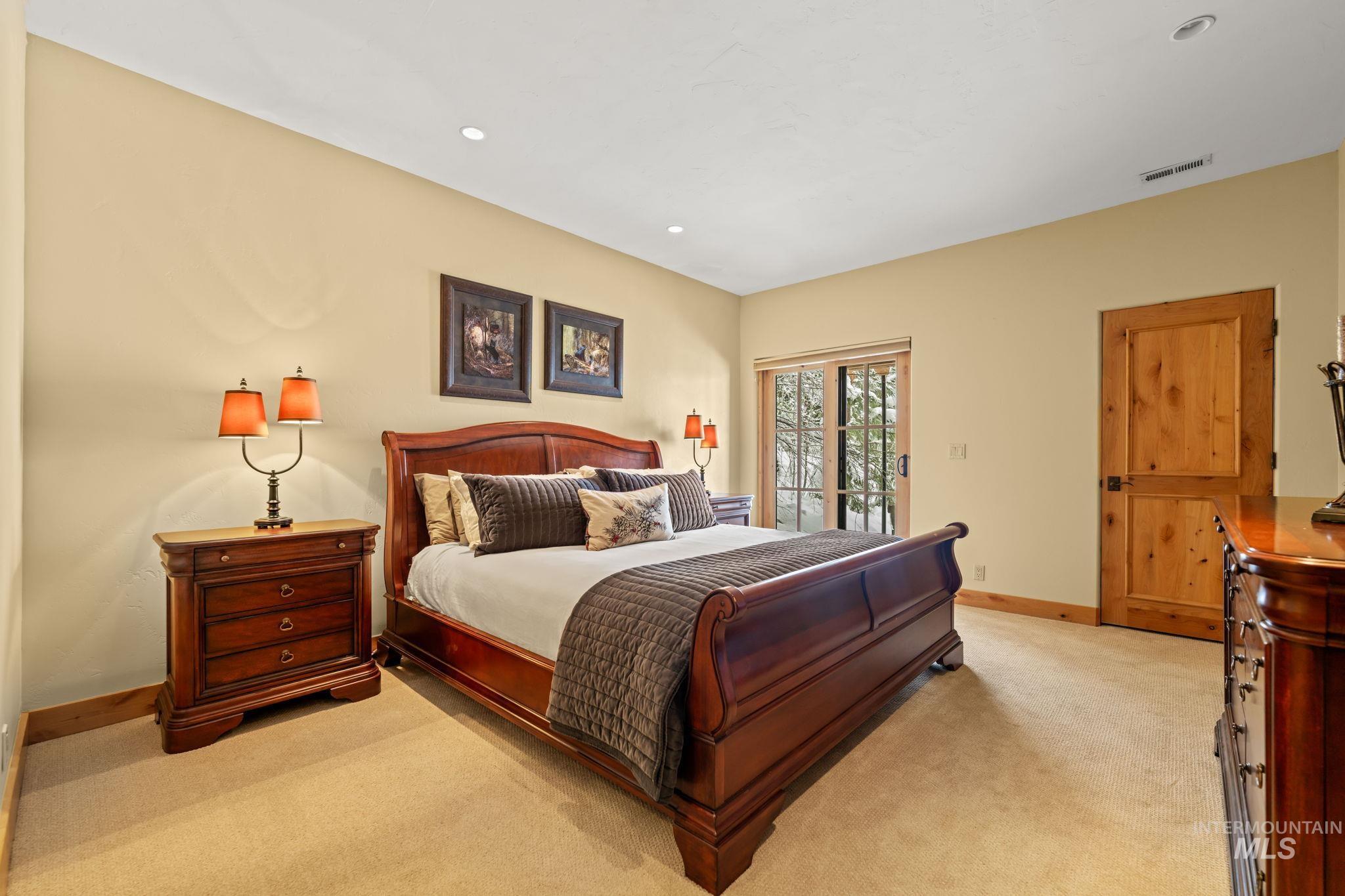 Bedroom with access to outside, recessed lighting, and light colored carpet