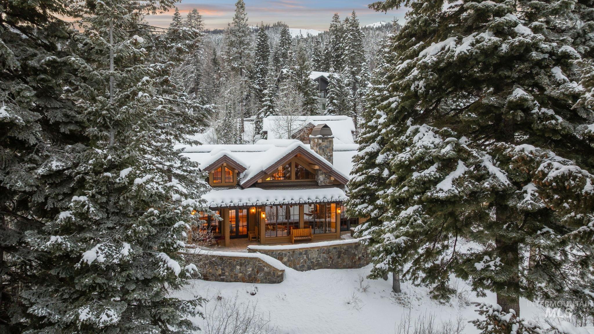 Snow covered house with a chimney and a porch