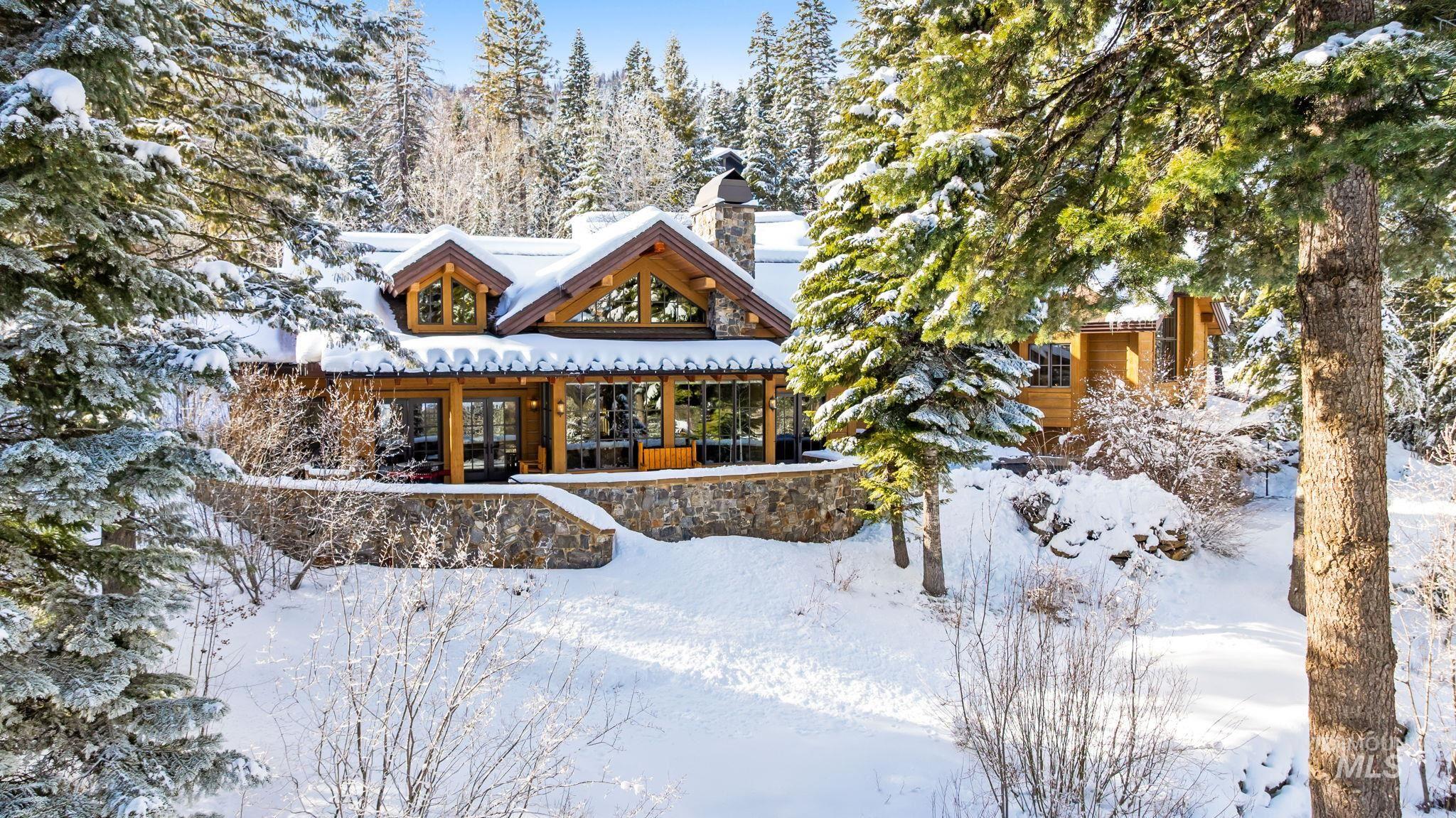 Snow covered property featuring a chimney and a porch