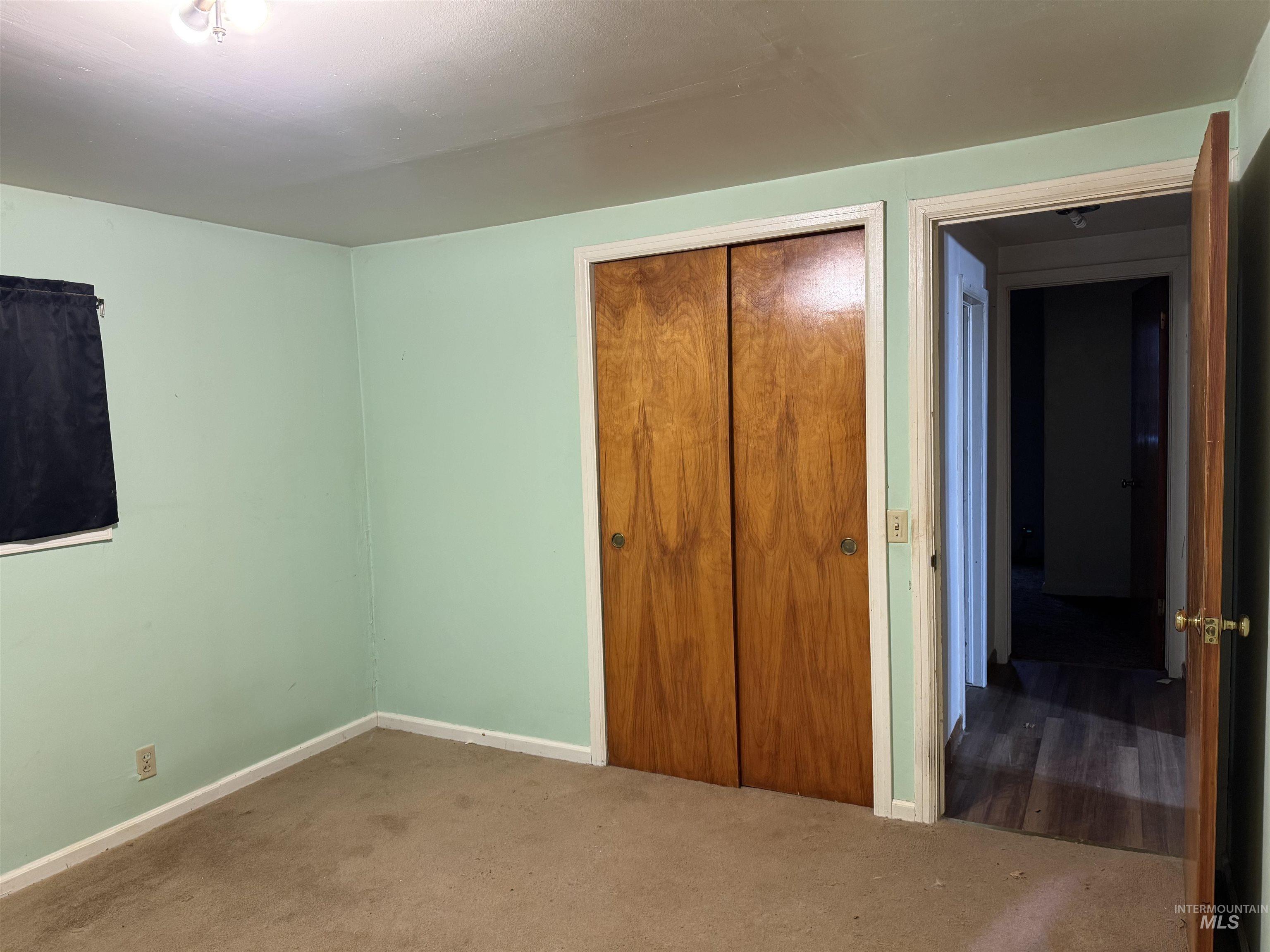 Unfurnished bedroom with a closet and carpet flooring