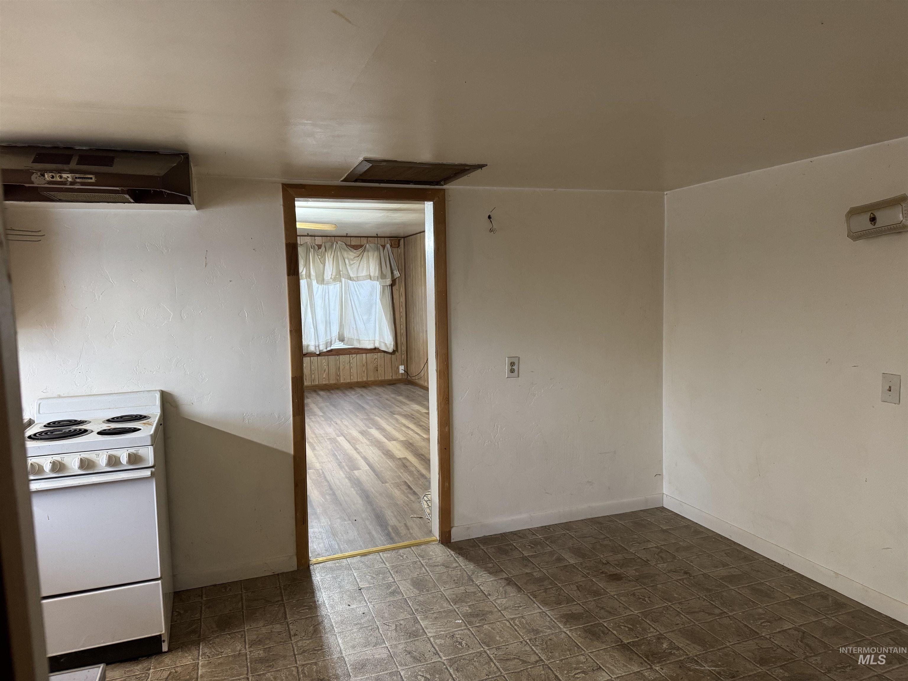 Kitchen with electric stove and ventilation hood