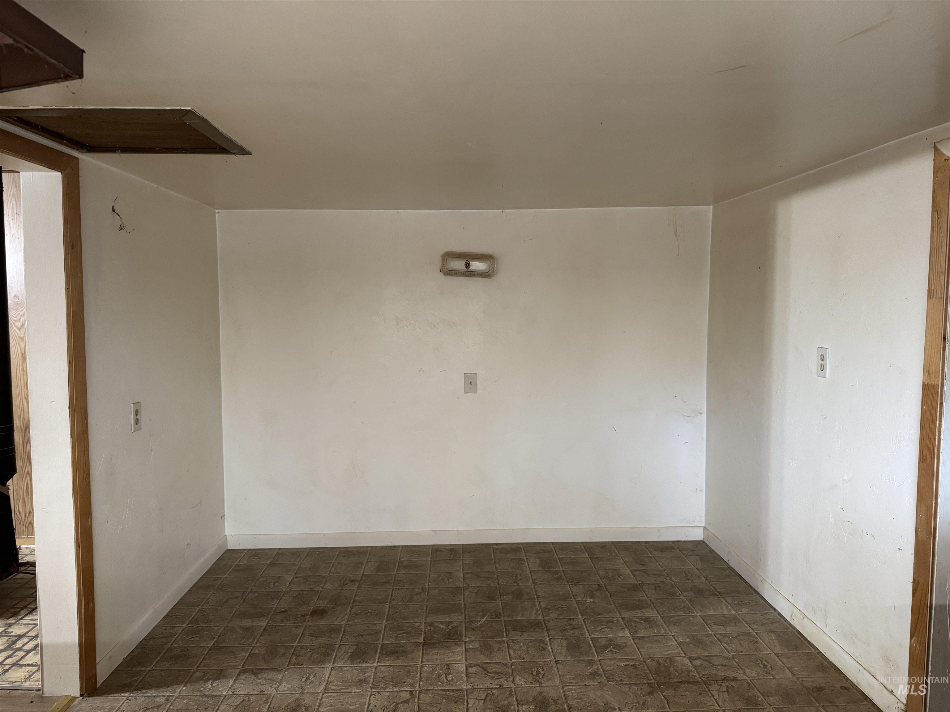 Unfurnished room featuring baseboards