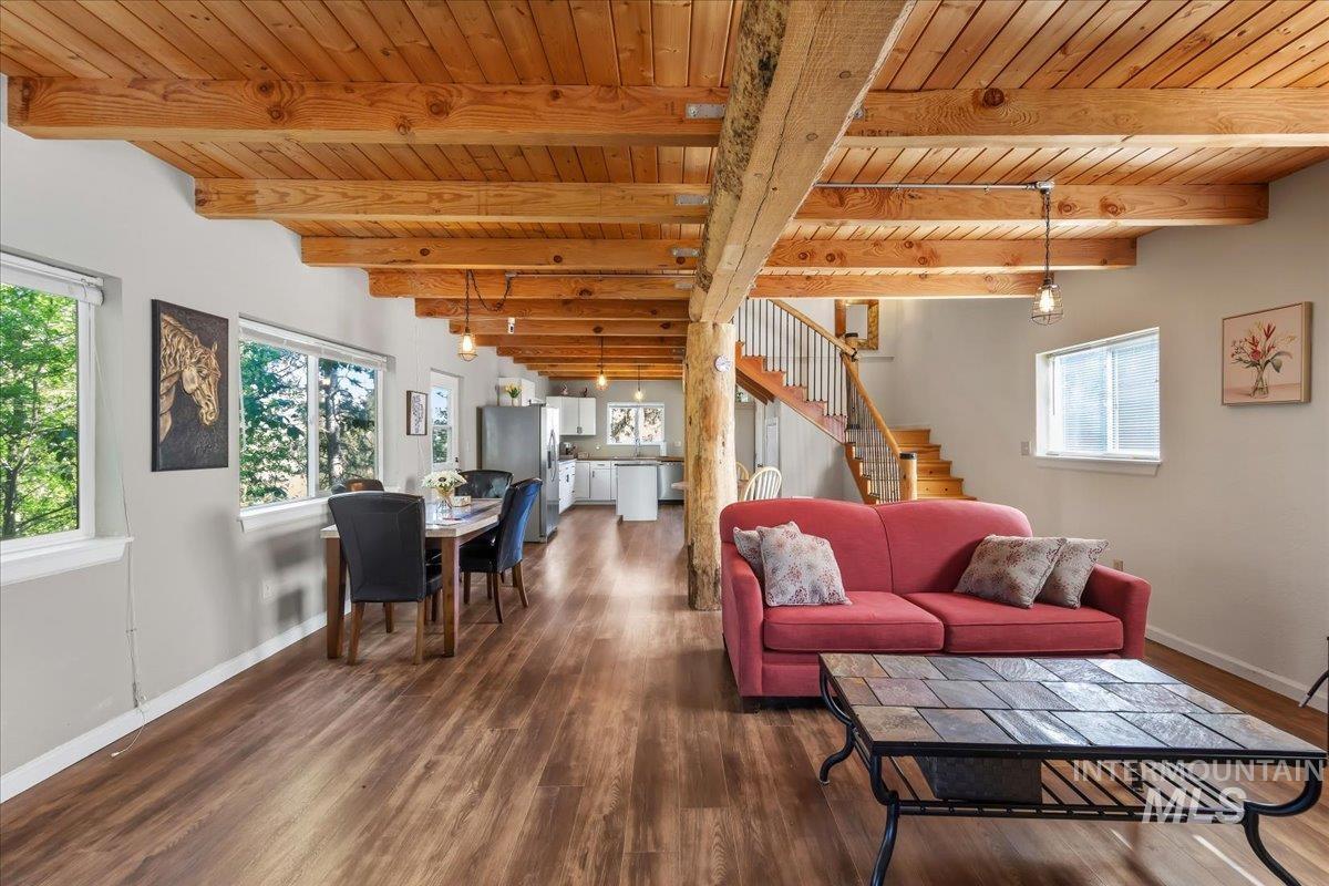 Exposed wood beam ceiling throughout the main living area, complemented by wood-finish flooring