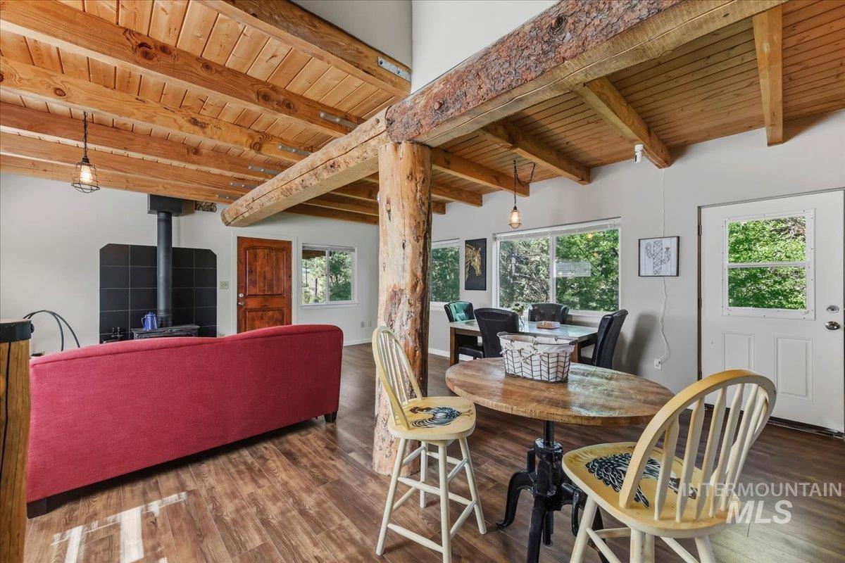 Exposed wood beam ceiling and structural posts defining an open living area