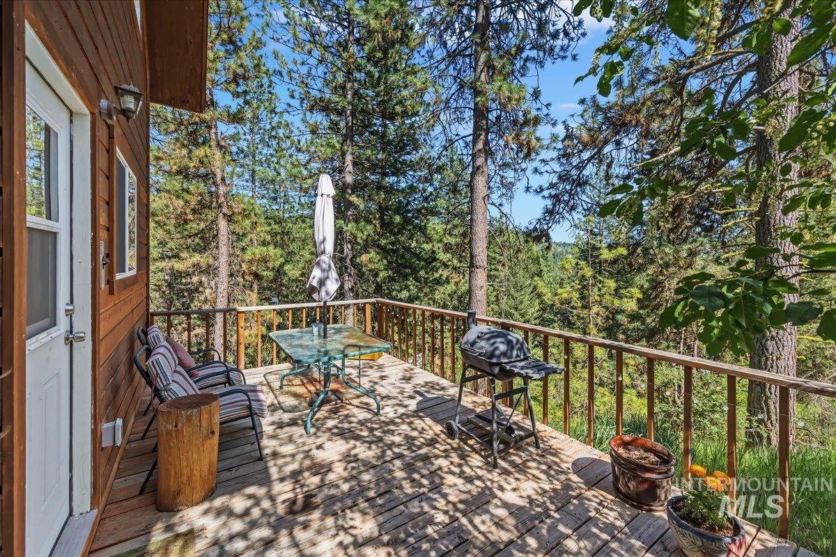 Wood-sided exterior featuring an expansive wooden deck with a natural wood railing