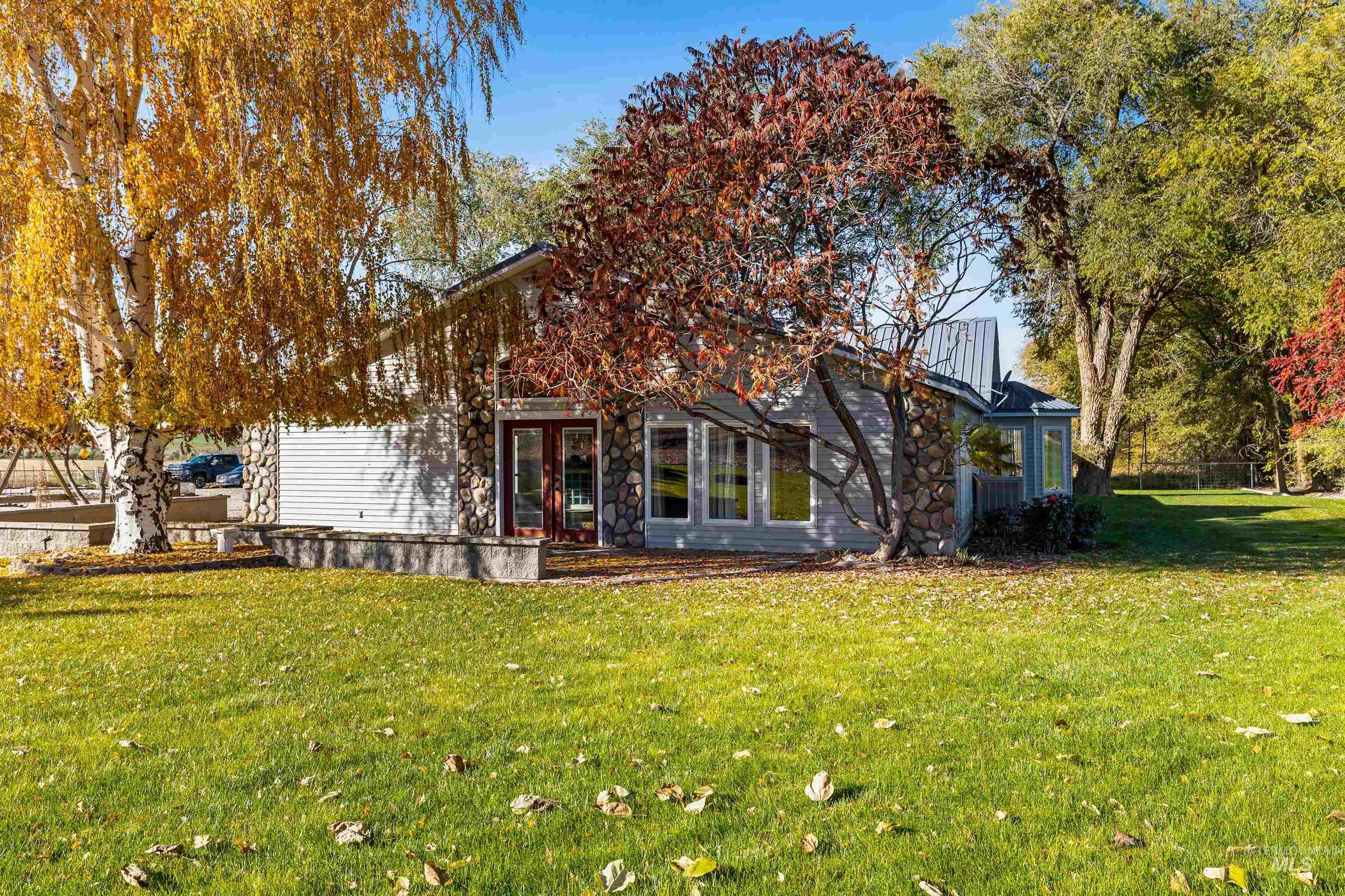 Back of house featuring a lawn and french doors