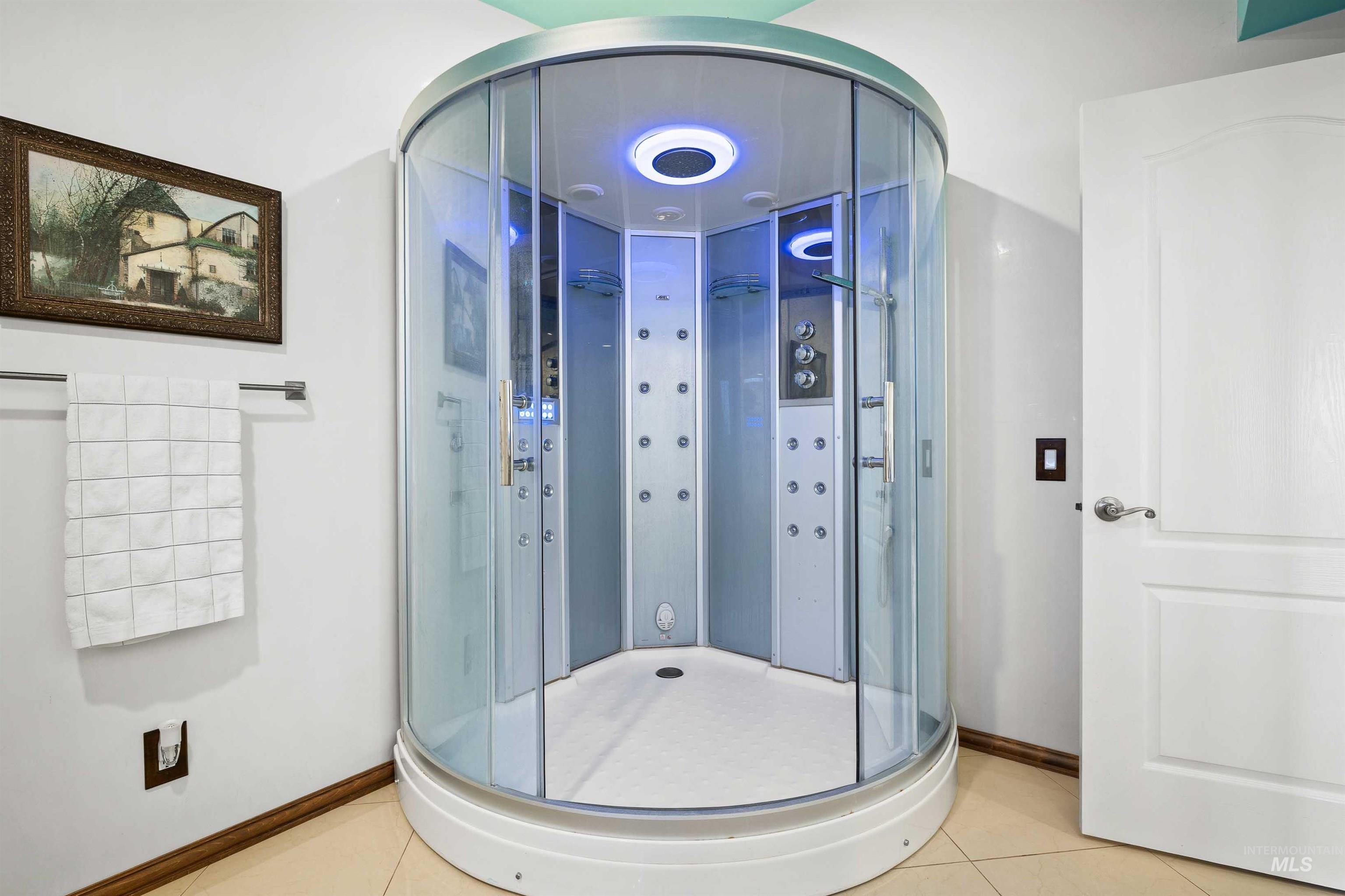 Bathroom featuring tile patterned floors and a stall shower