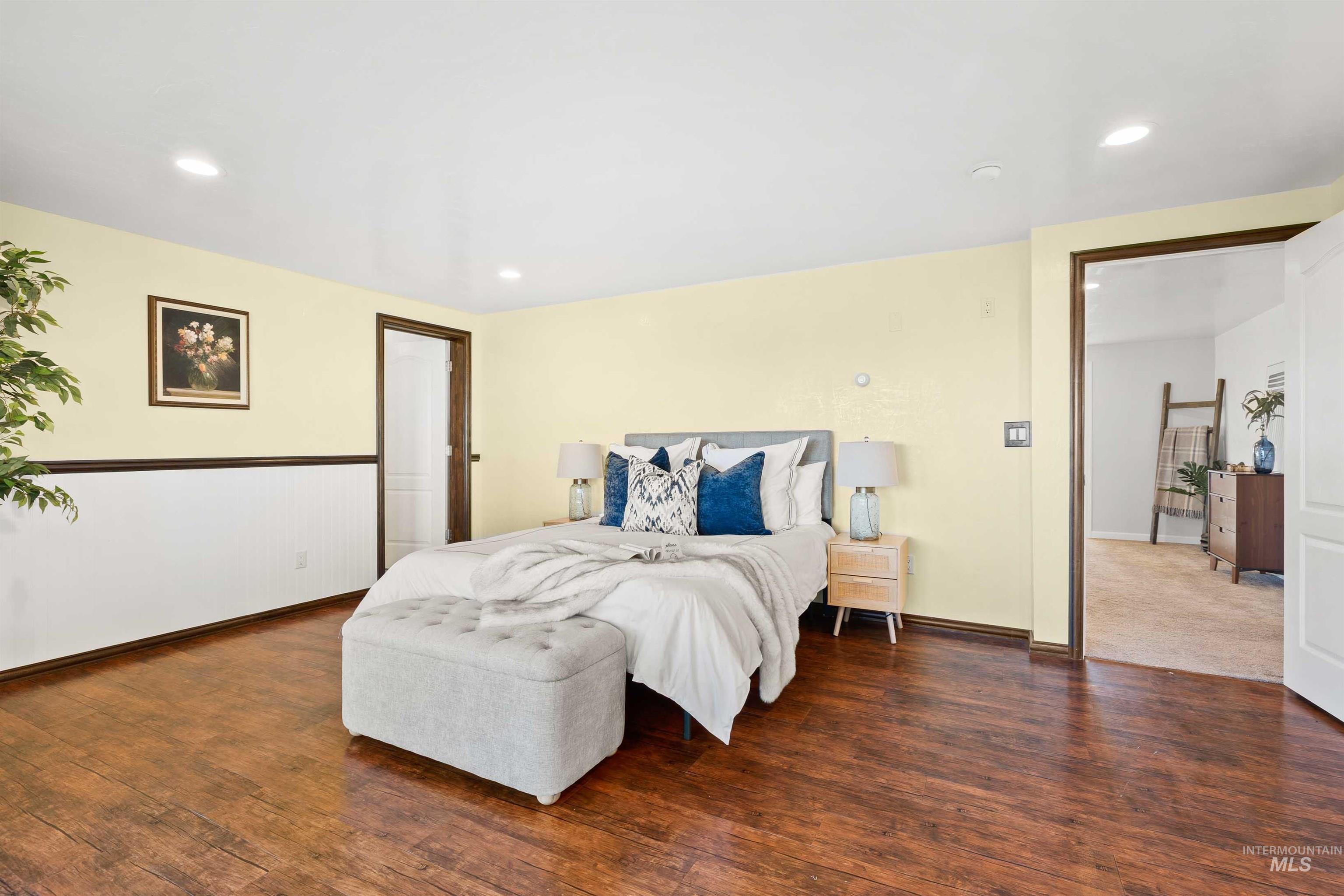 Bedroom with wood finished floors and recessed lighting