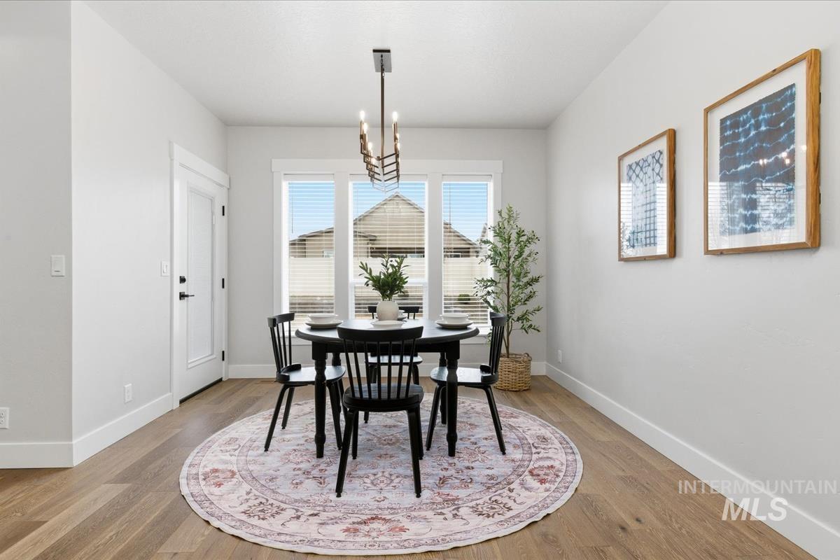 Dining area with a chandelier and light wood finished floors
