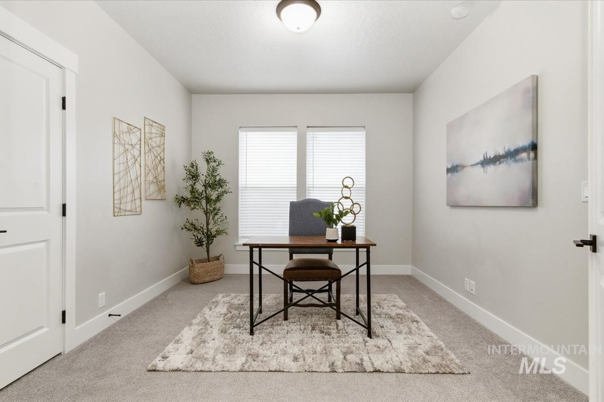 Office area featuring baseboards and light colored carpet