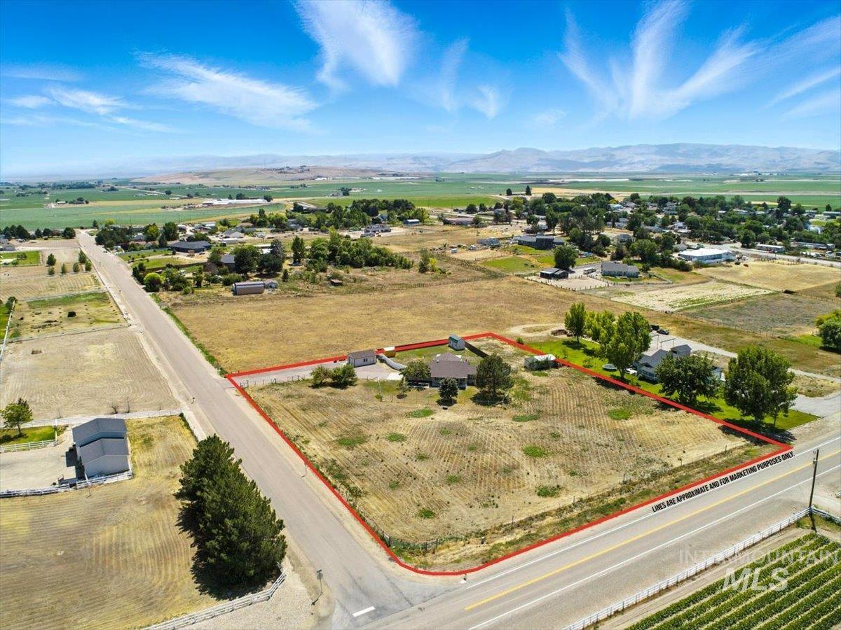 Aerial view of sparsely populated area featuring property boundaries highlighted and mountains