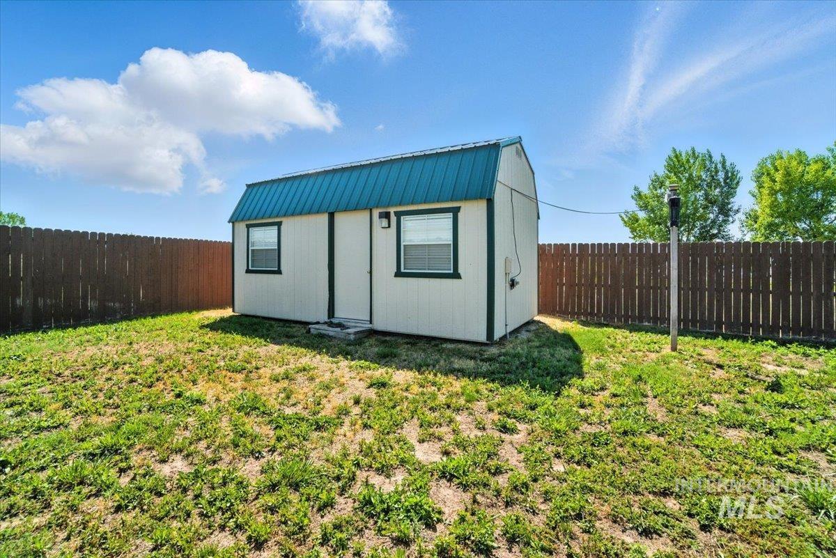 View of outdoor structure featuring a fenced backyard