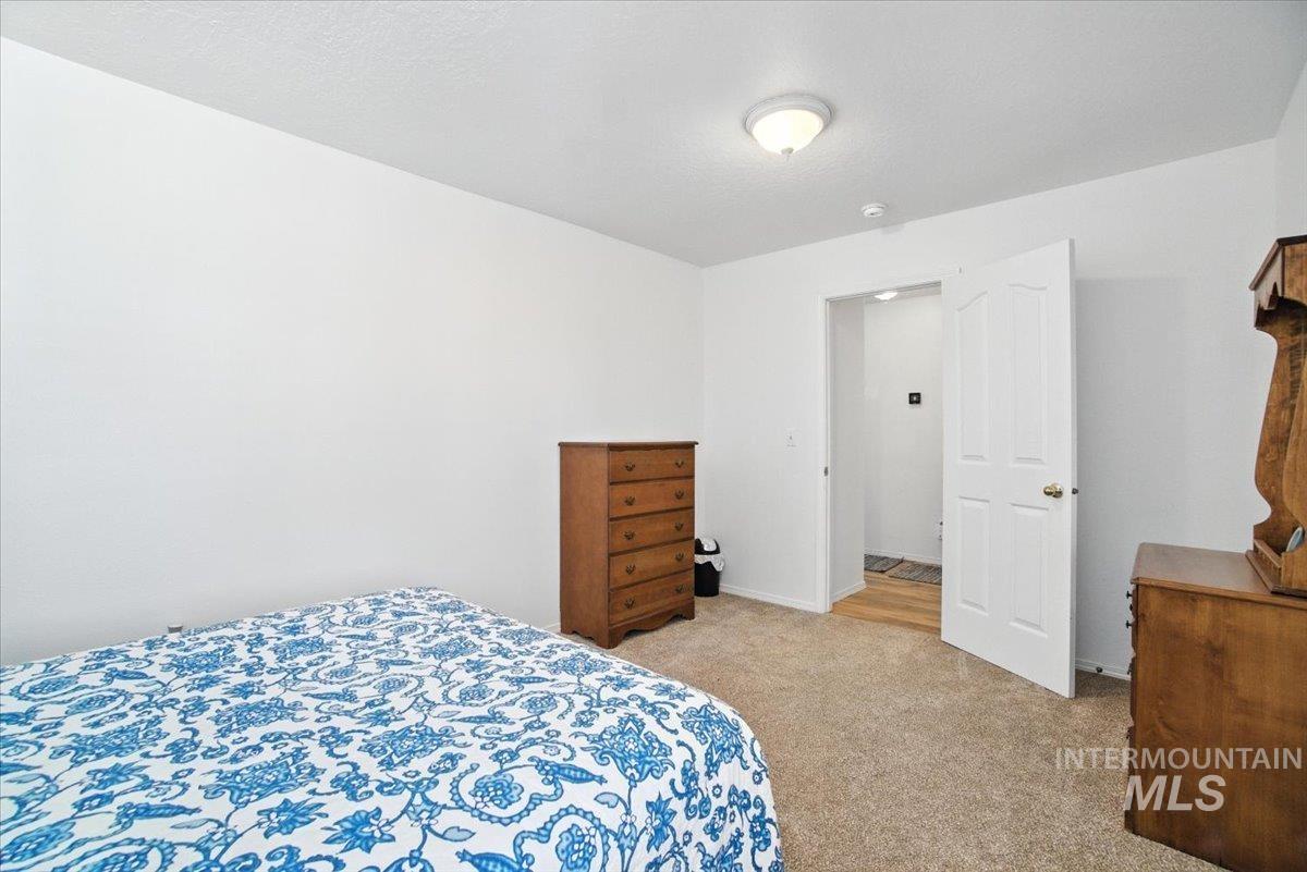 Bedroom featuring carpet floors and baseboards