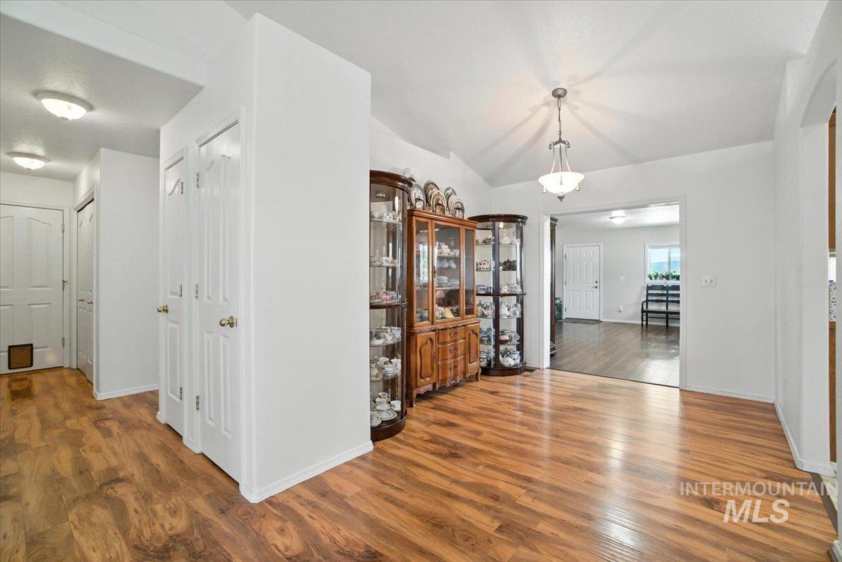 Corridor featuring wood finished floors and lofted ceiling