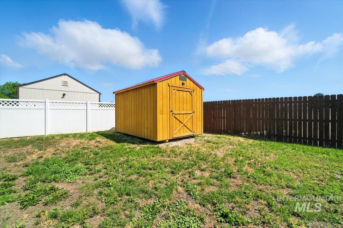 View of shed with a fenced backyard
