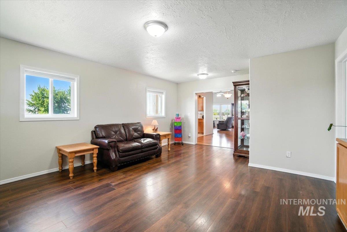 Living room with dark wood-style floors and a textured ceiling