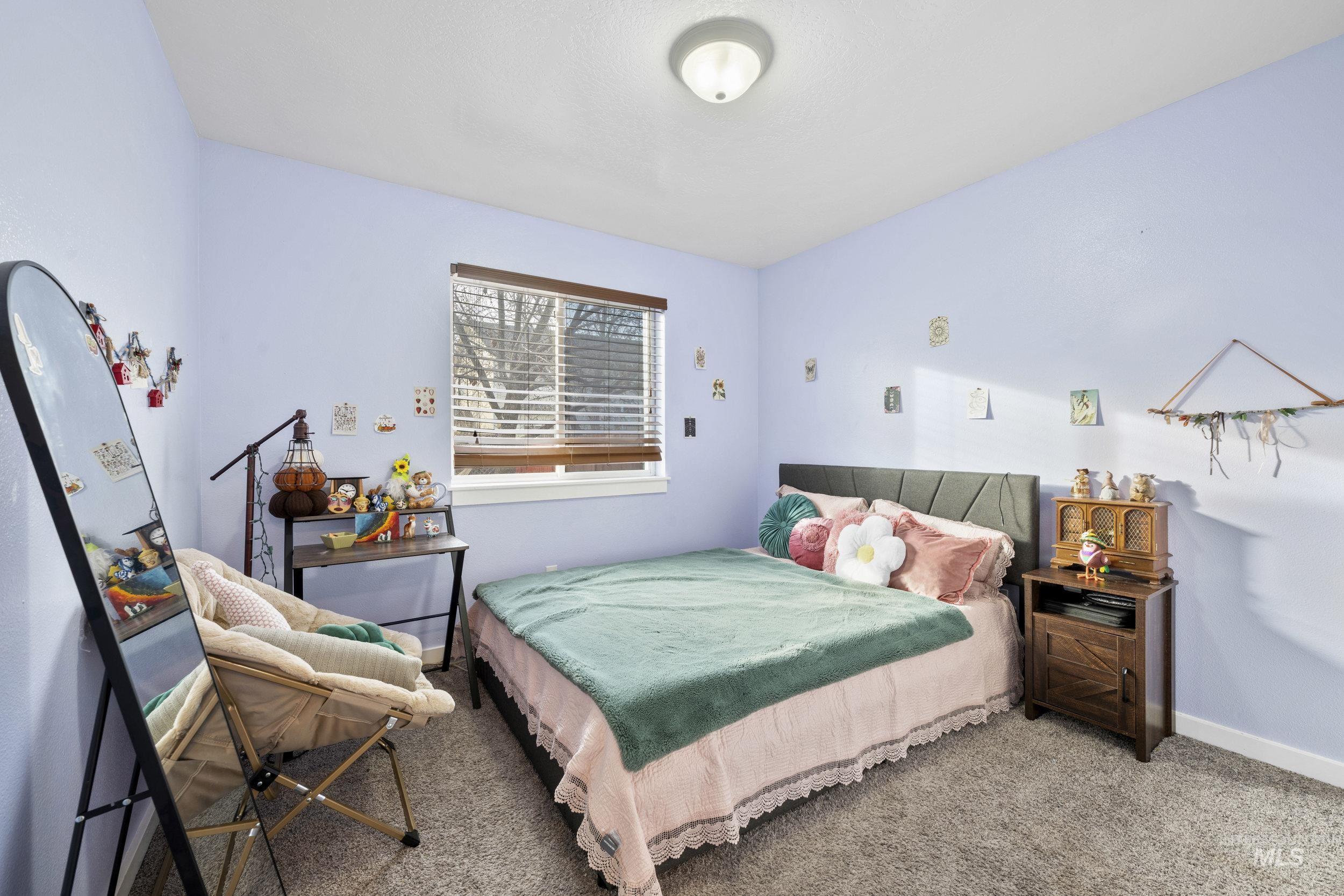 Carpeted bedroom featuring baseboards