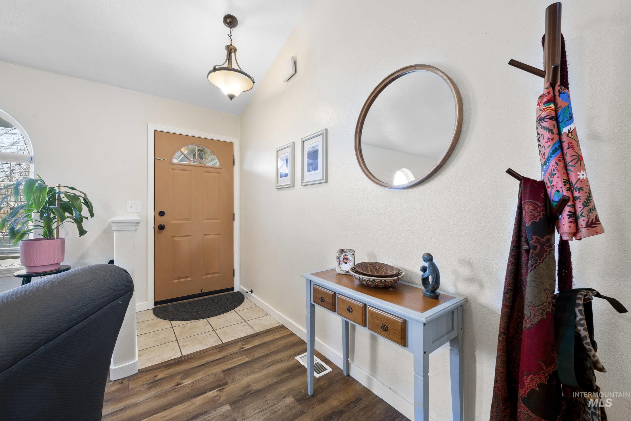 Entrance foyer with wood finished floors and baseboards