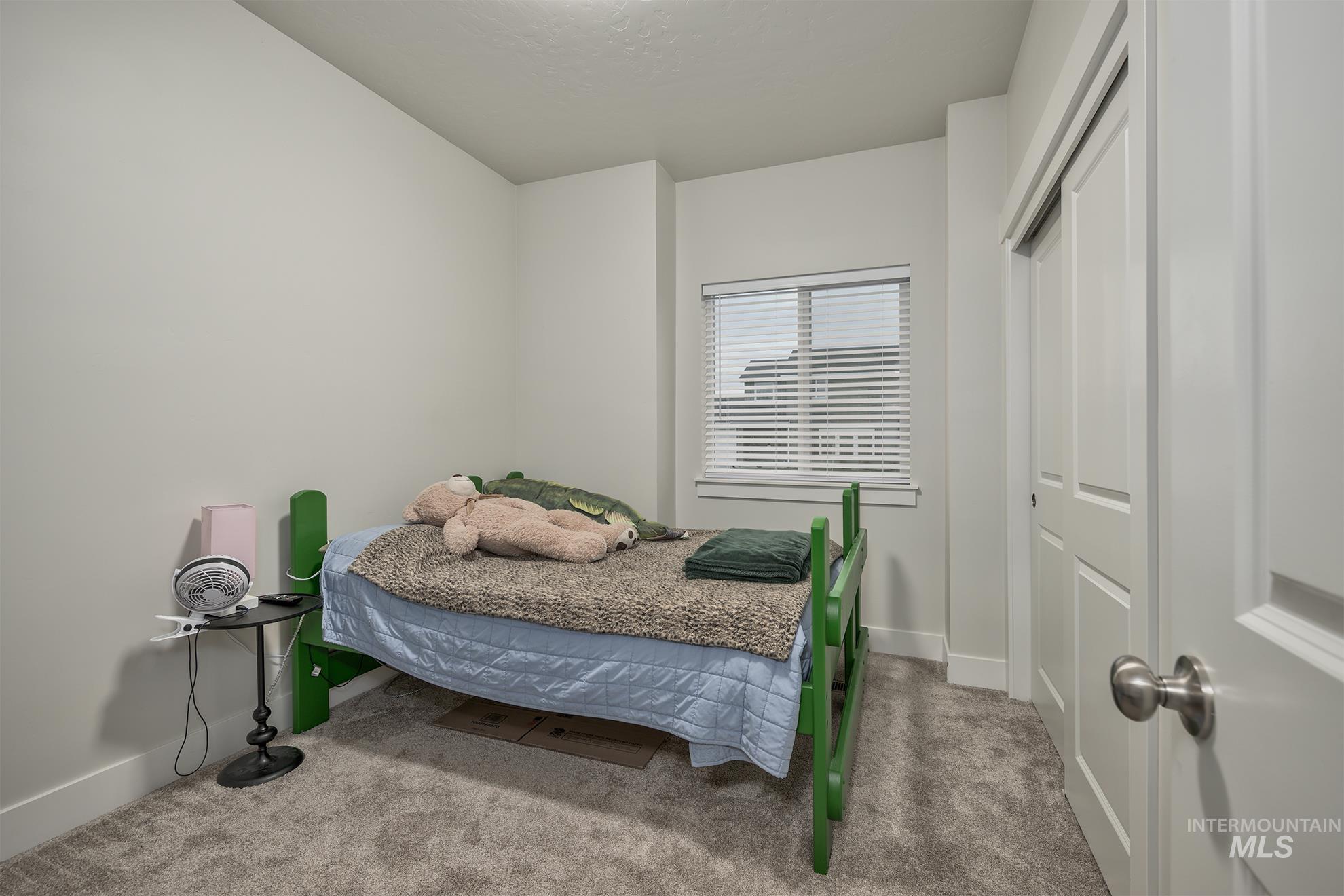 Bedroom featuring carpet and a closet