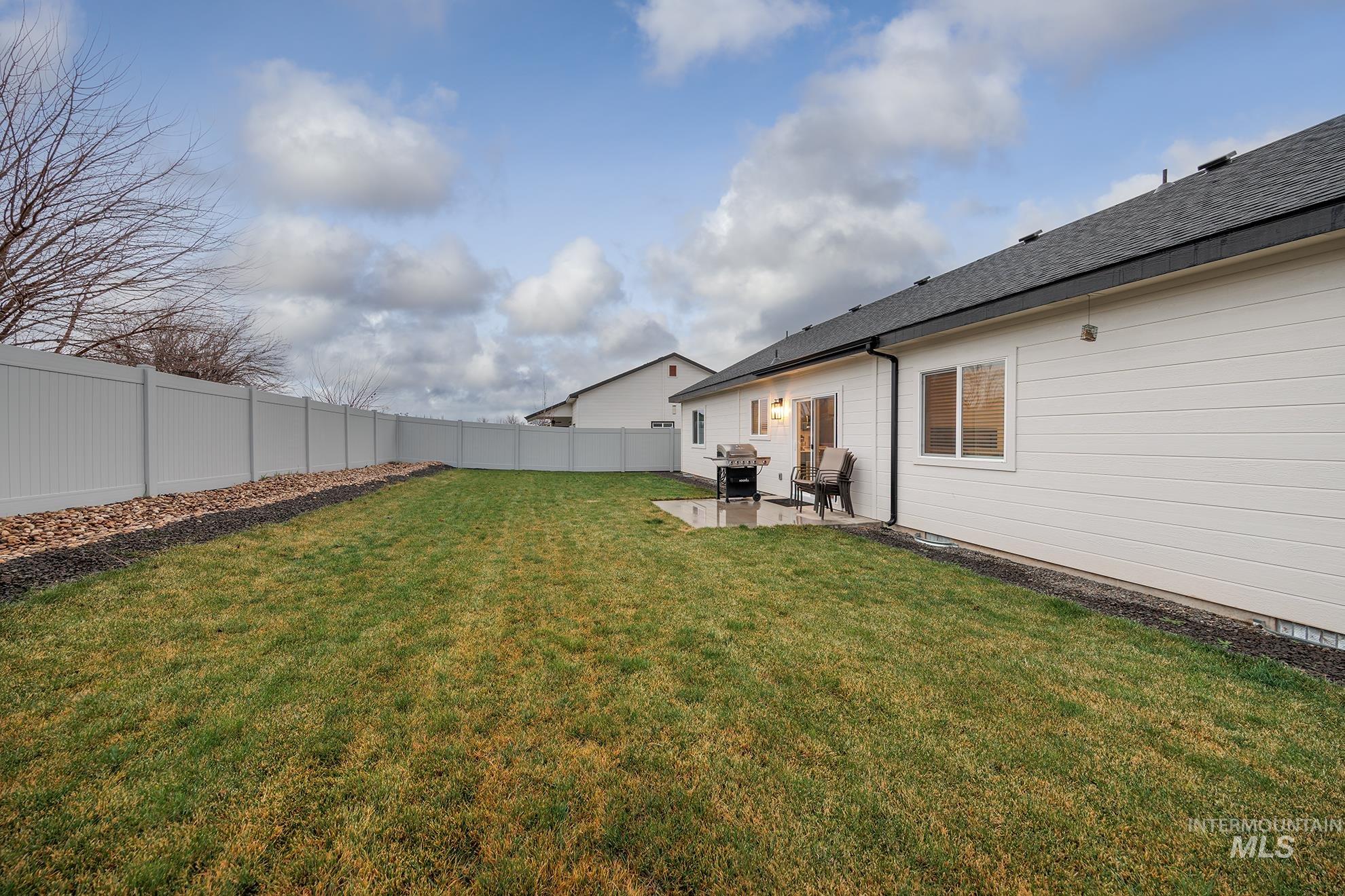 Fenced backyard featuring a patio
