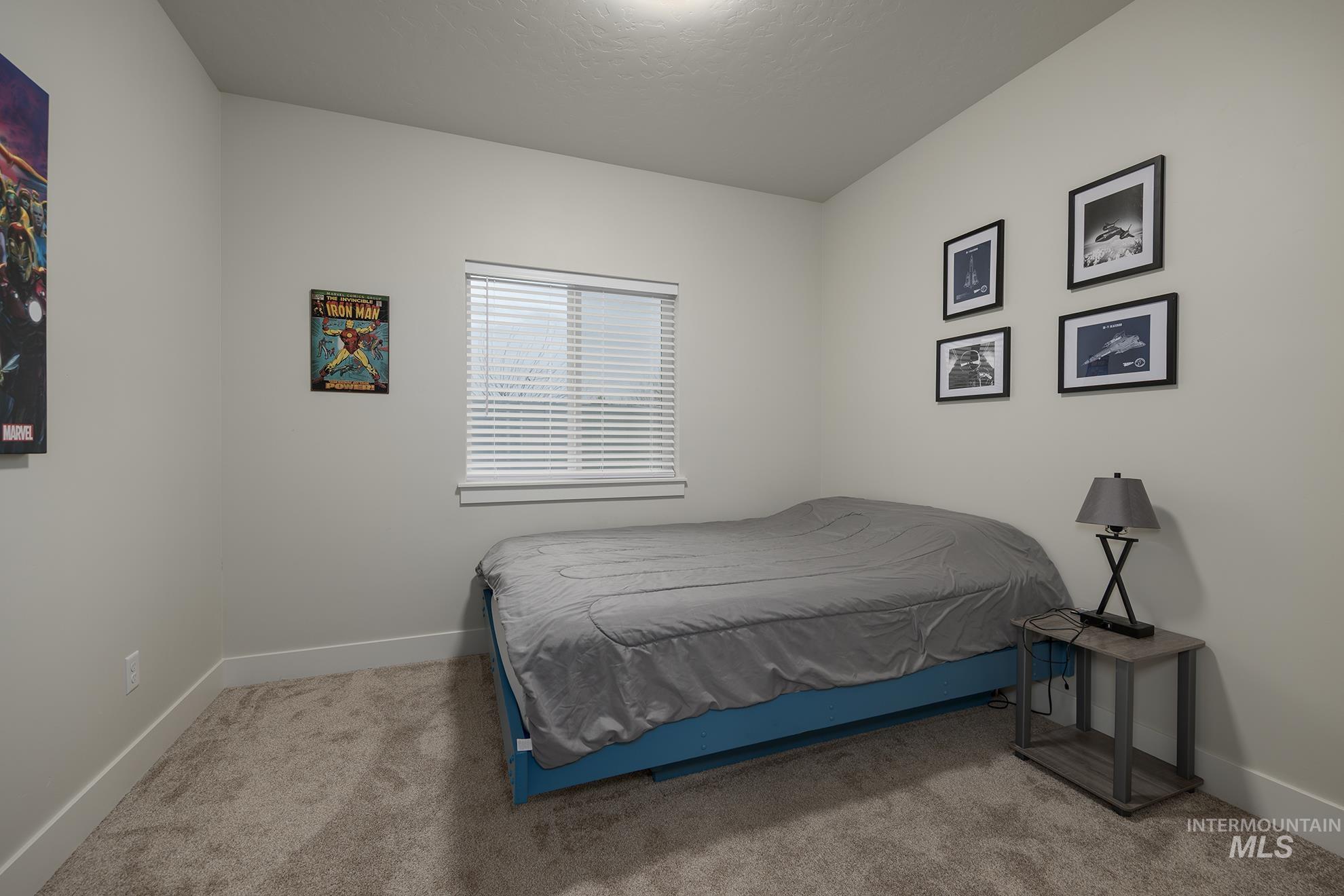 Bedroom featuring light colored carpet and baseboards