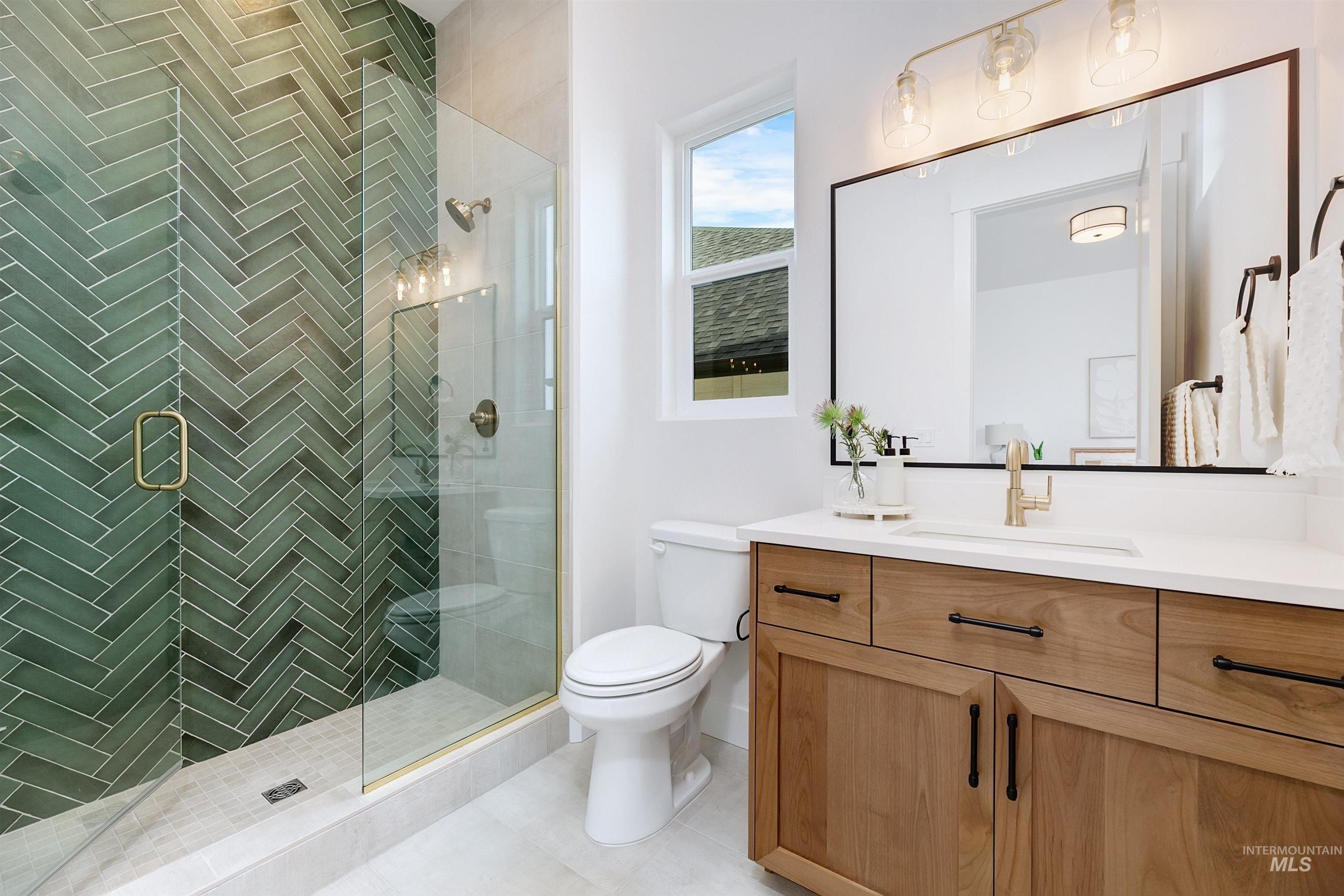 Bathroom with vanity, a stall shower, and light tile patterned floors