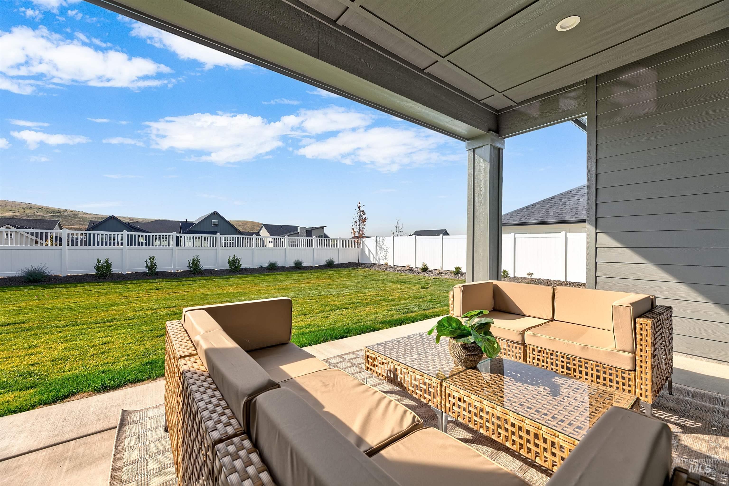 Fenced backyard featuring outdoor furniture and a patio area