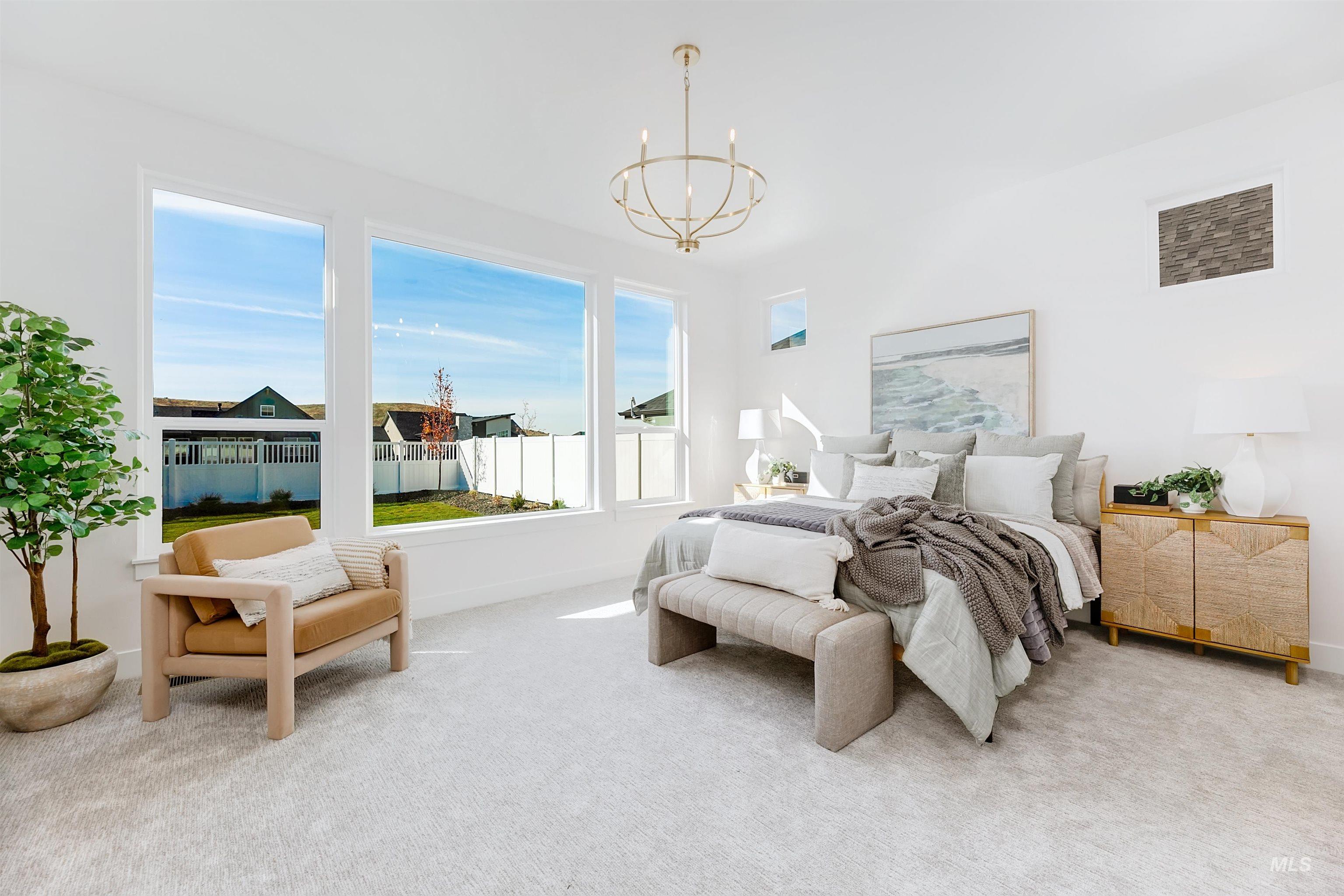 Bedroom featuring suspended lighting and carpet