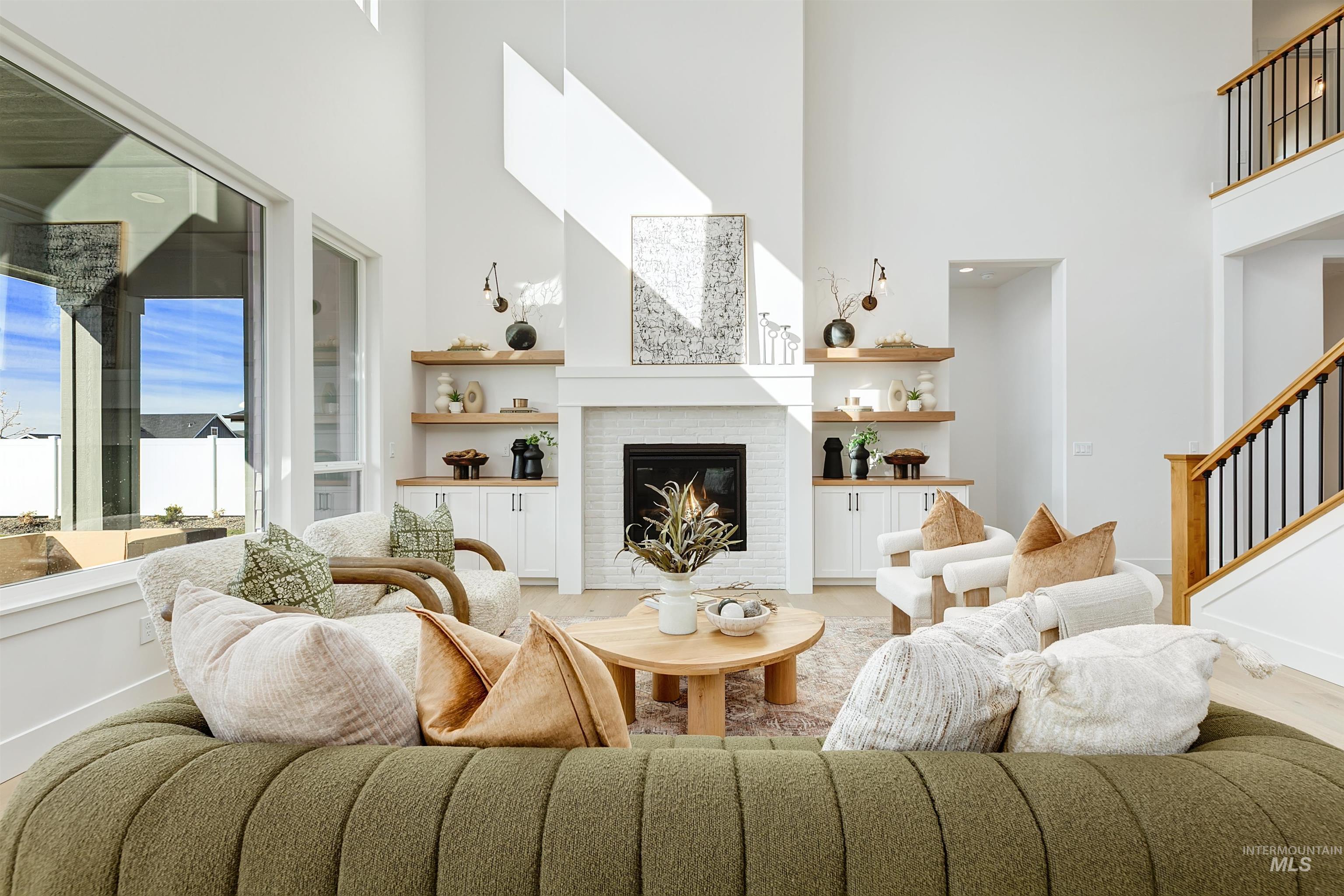 Living room featuring a high ceiling and a fireplace
