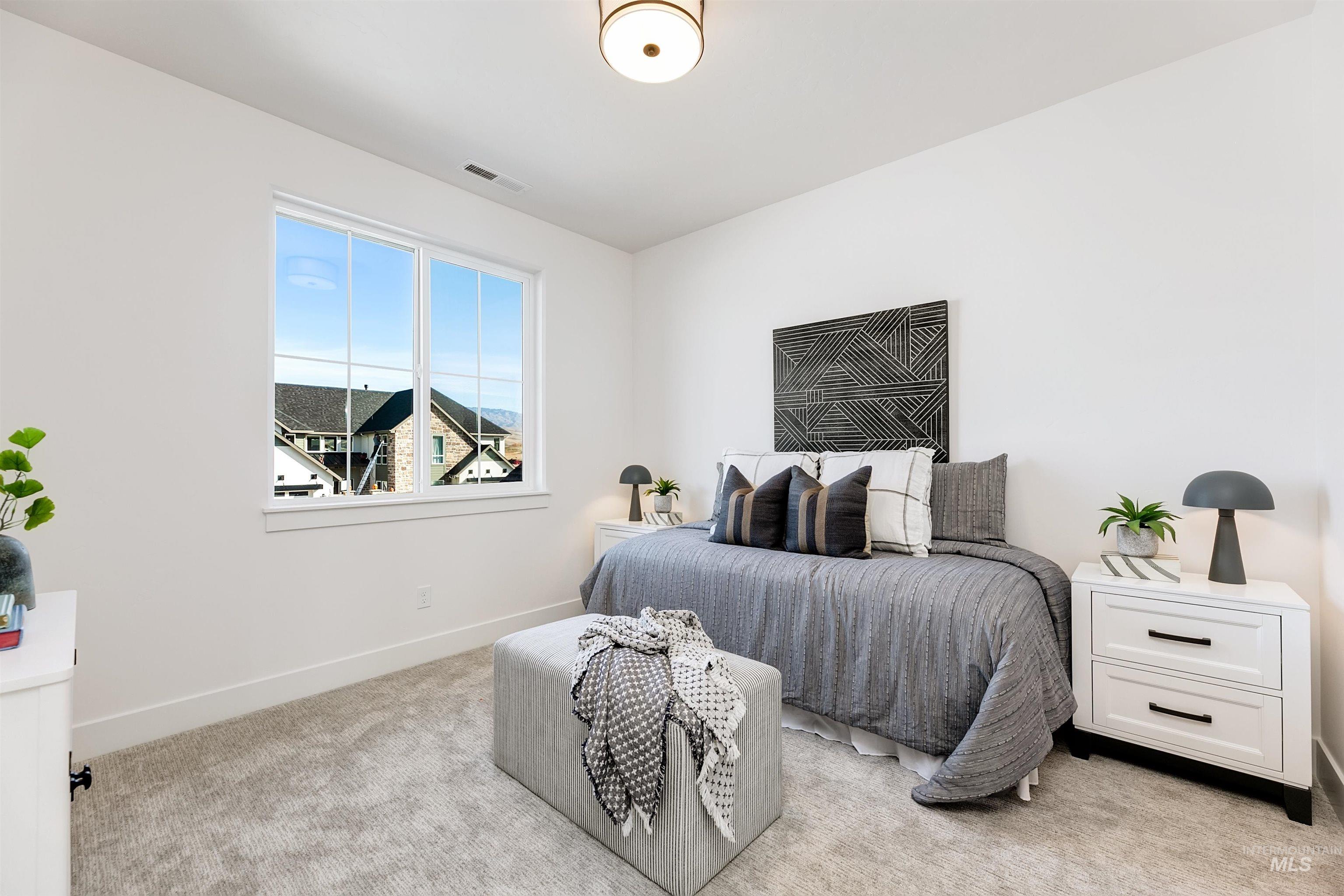 Bedroom with light carpet and baseboards
