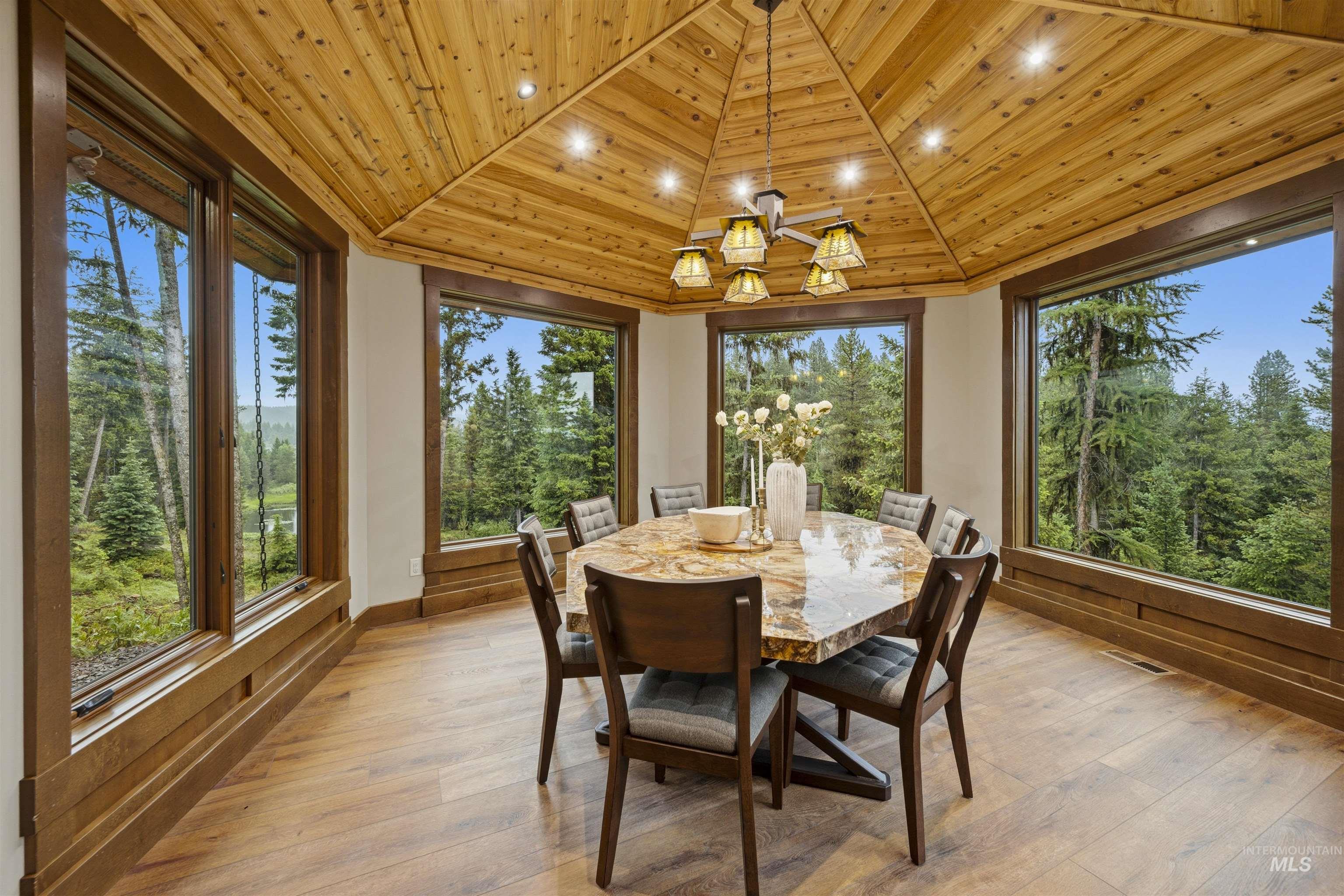 Dining area with wood-finish flooring and a wood-paneled, vaulted ceiling