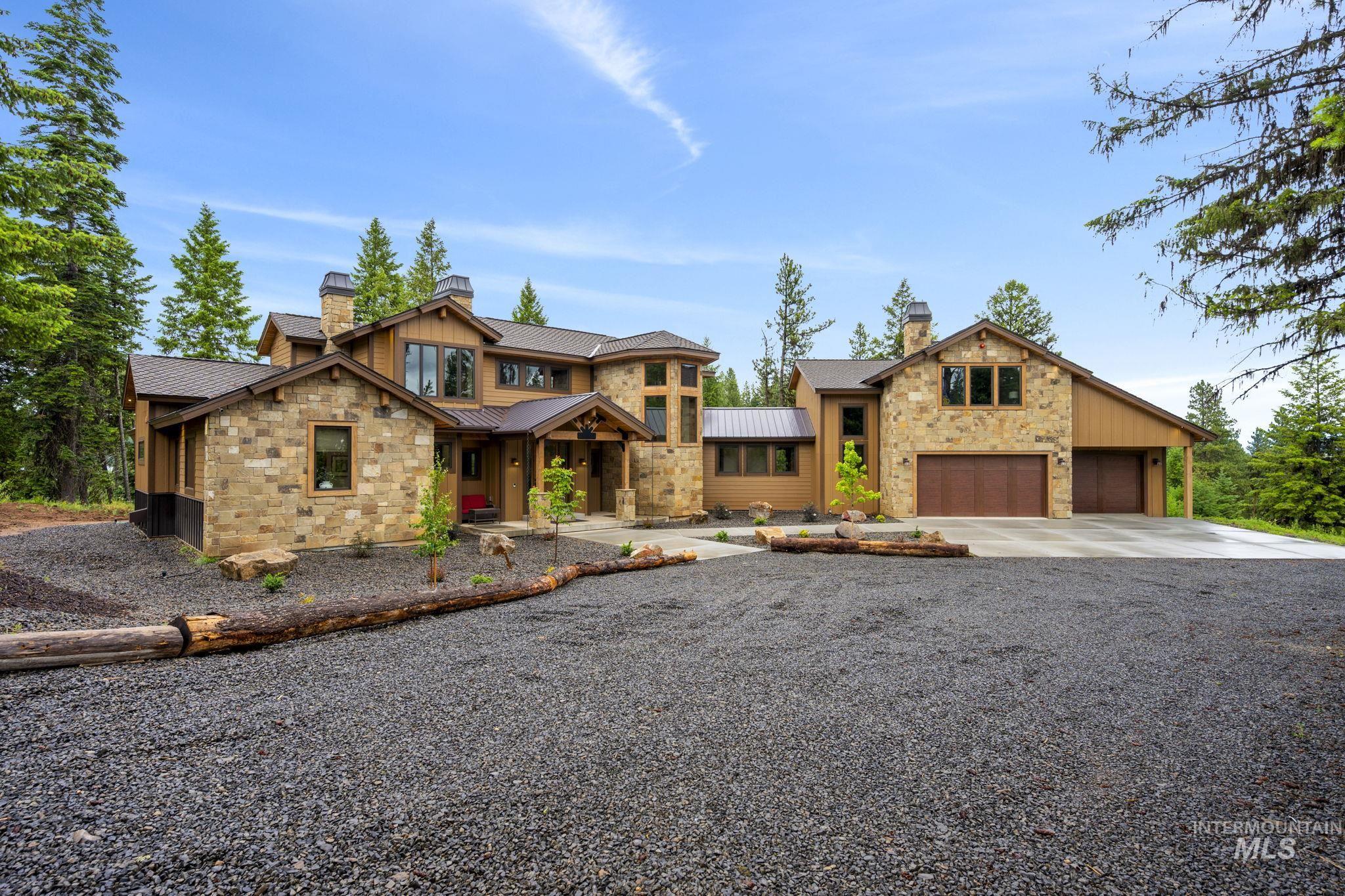 Stone and wood-sided exterior featuring multiple gables